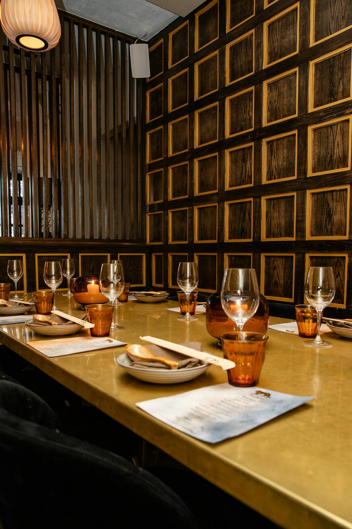 a private dining room with a brass table
