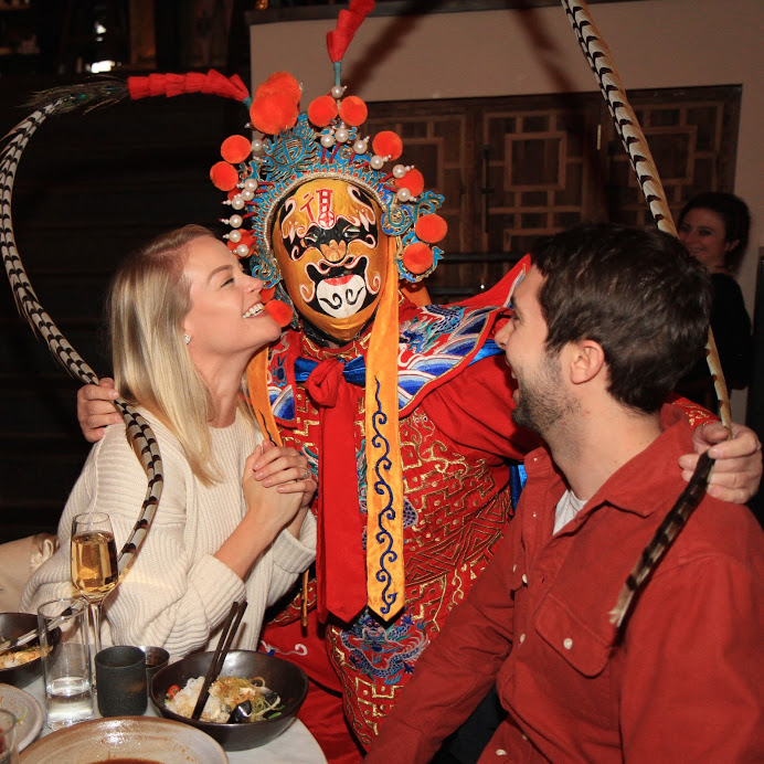 a man in a garment with a woman in a restaurant