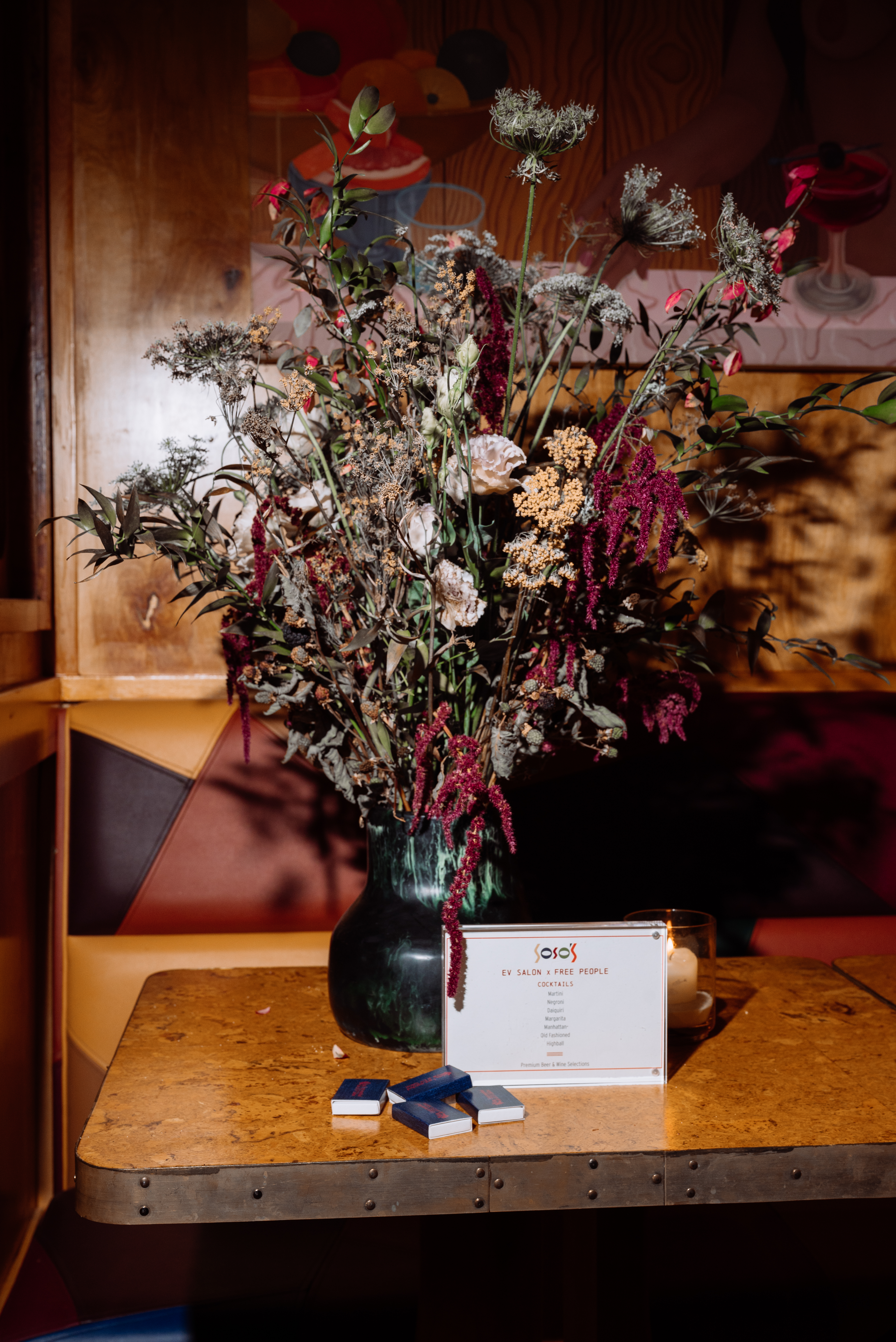a vase with flowers and a card on a table
