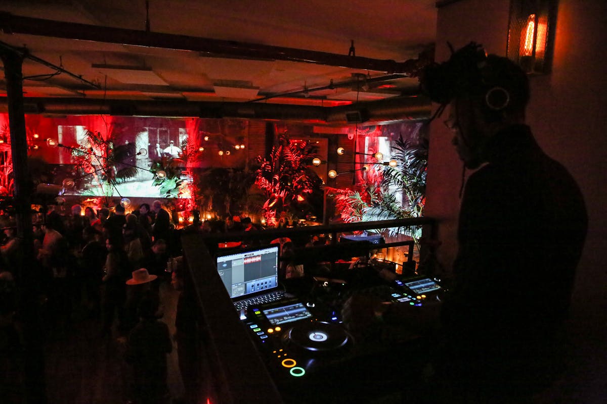 a view of the DJ and the system at a dark party