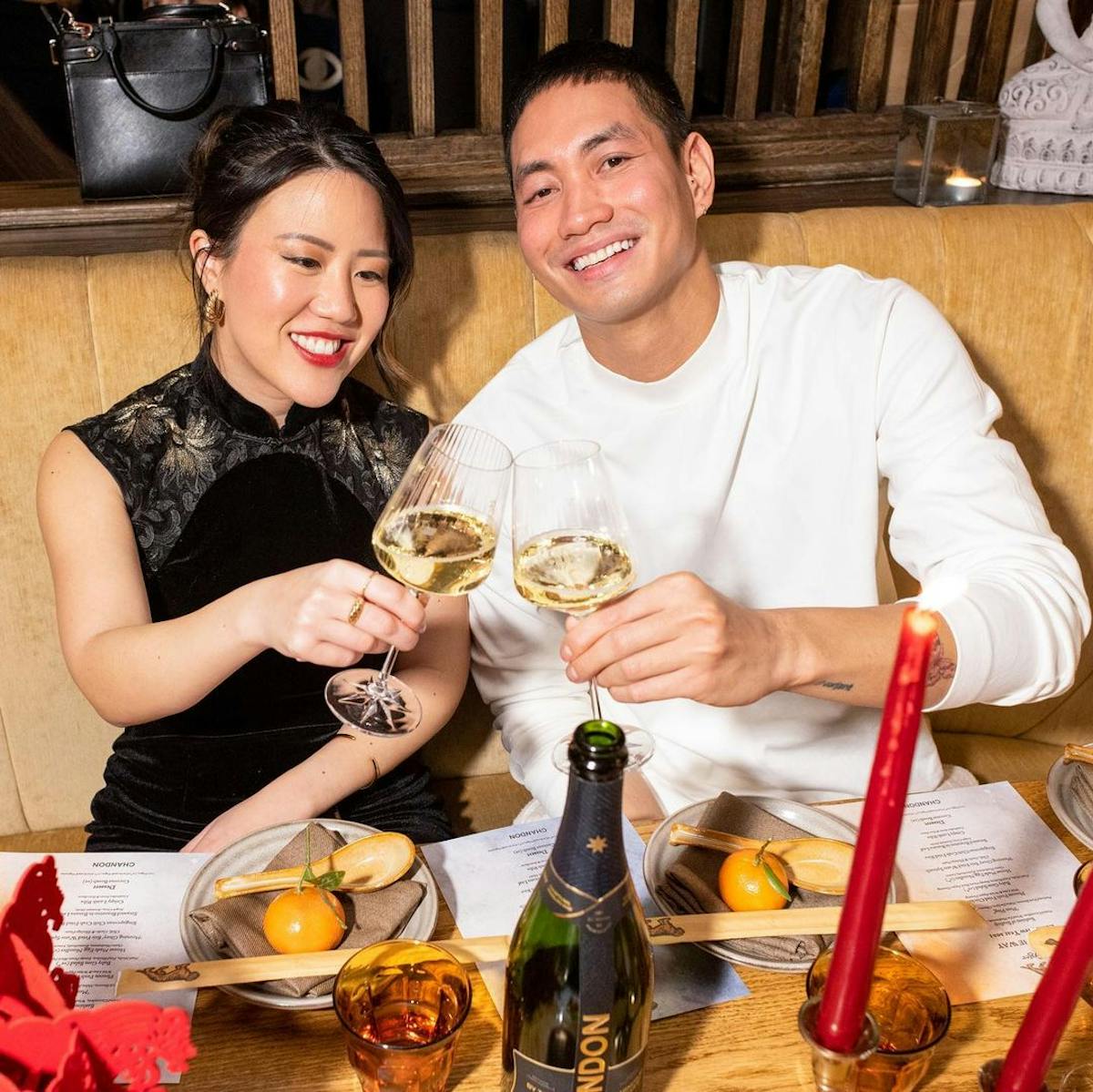 a couple with cocktails doing a cheers