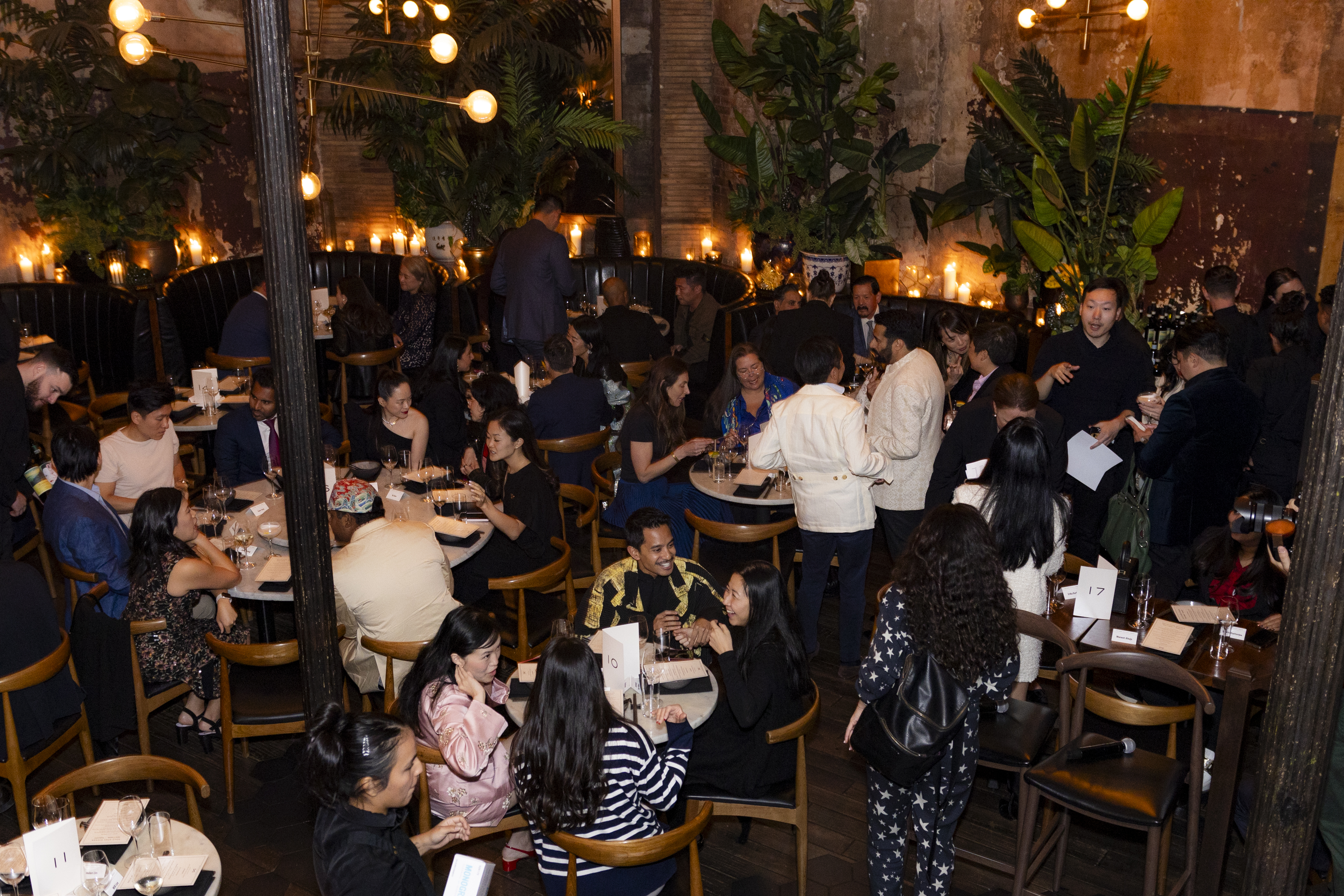 a group of people sitting at tables in a restaurant