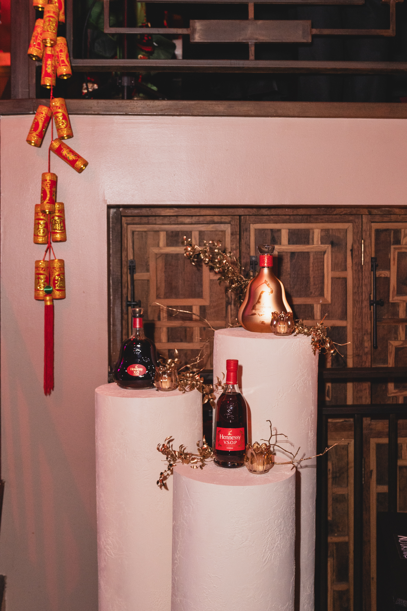 a group of bottles on a white pedestal