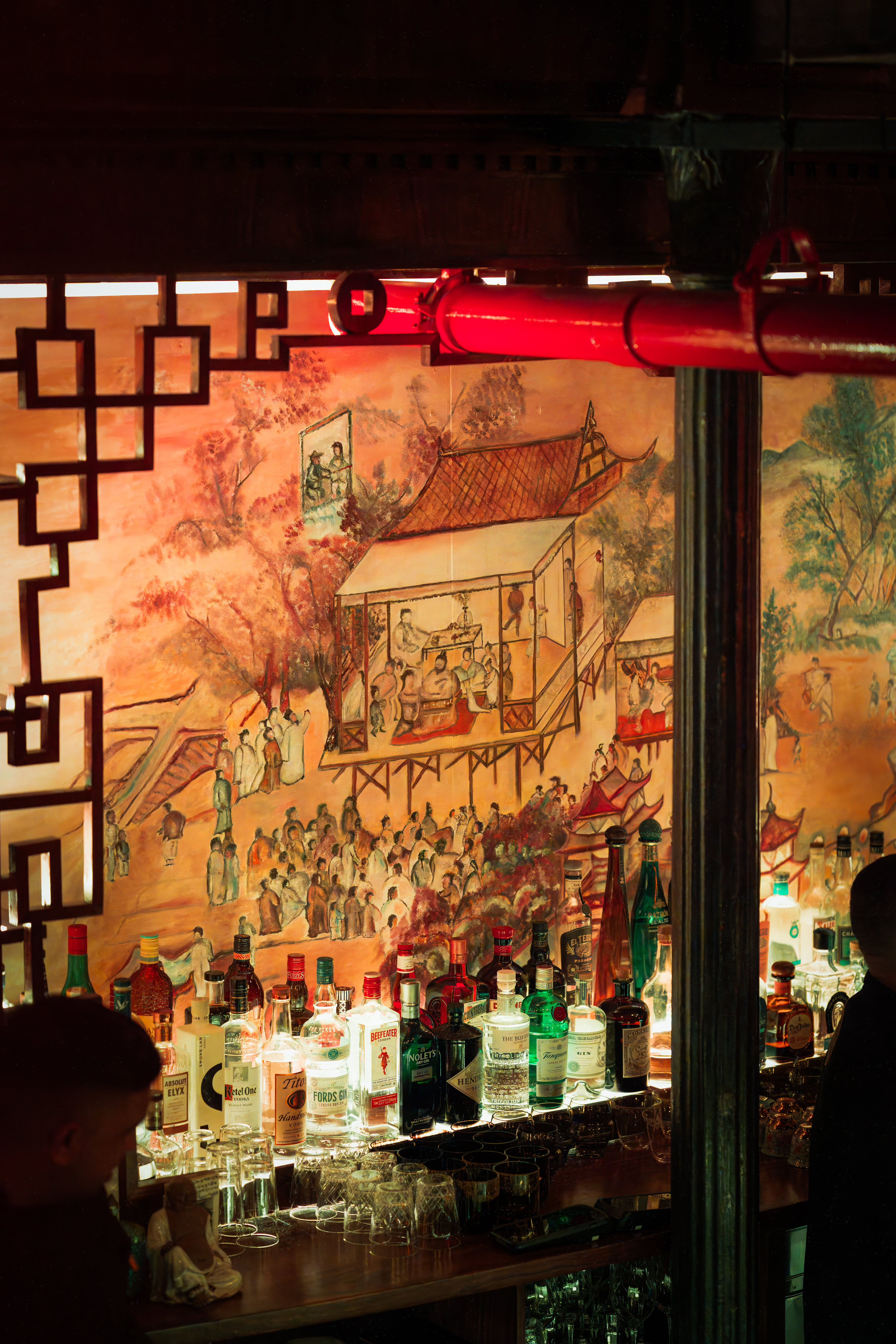 a bar with a painting of a scene of a chinese town