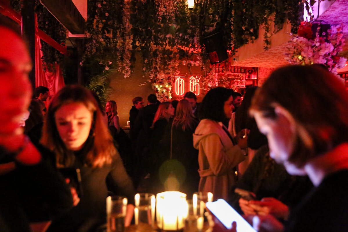 a crowd of people in a cocktail bar