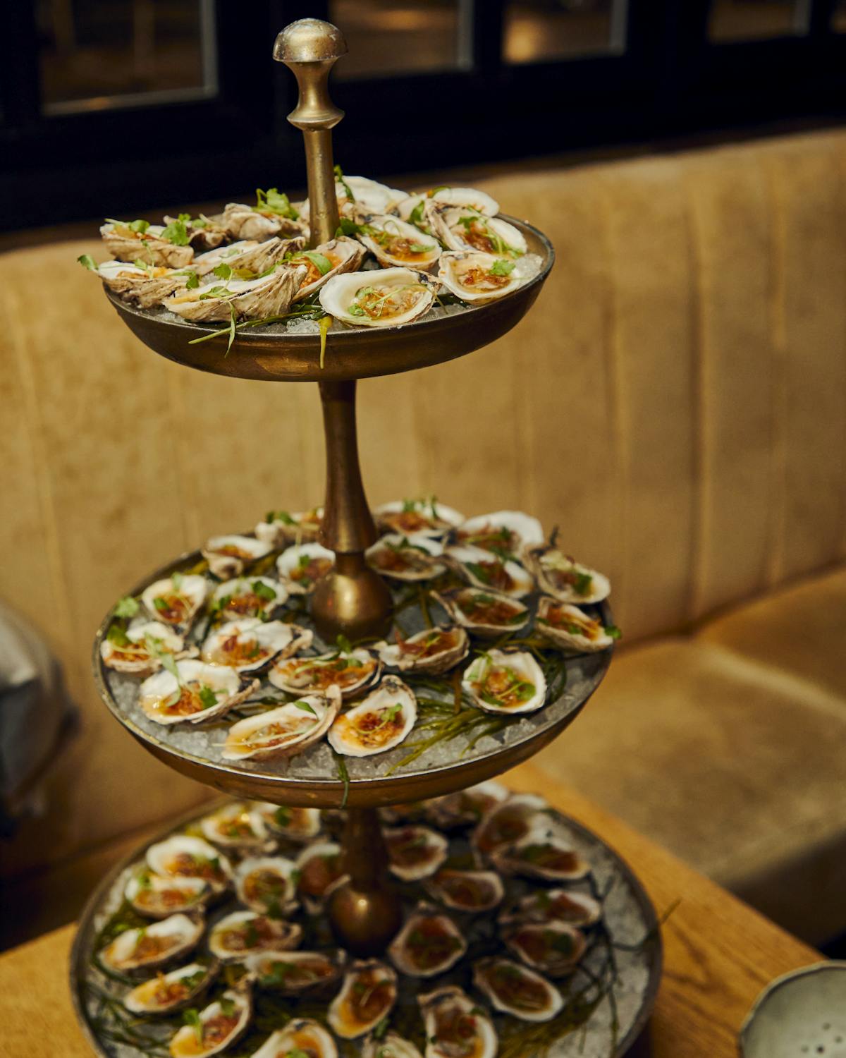 a three tiered serving tray filled with food