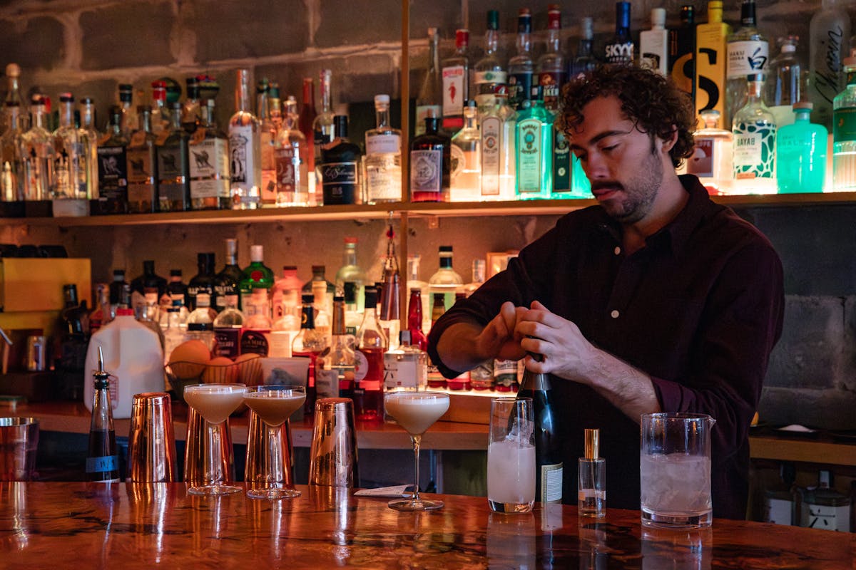 a man making a cocktail drinks