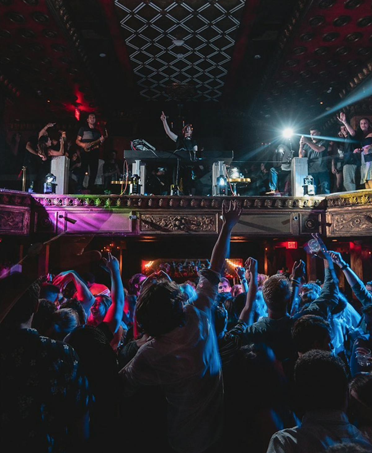 a group of people on a stage in front of a crowd