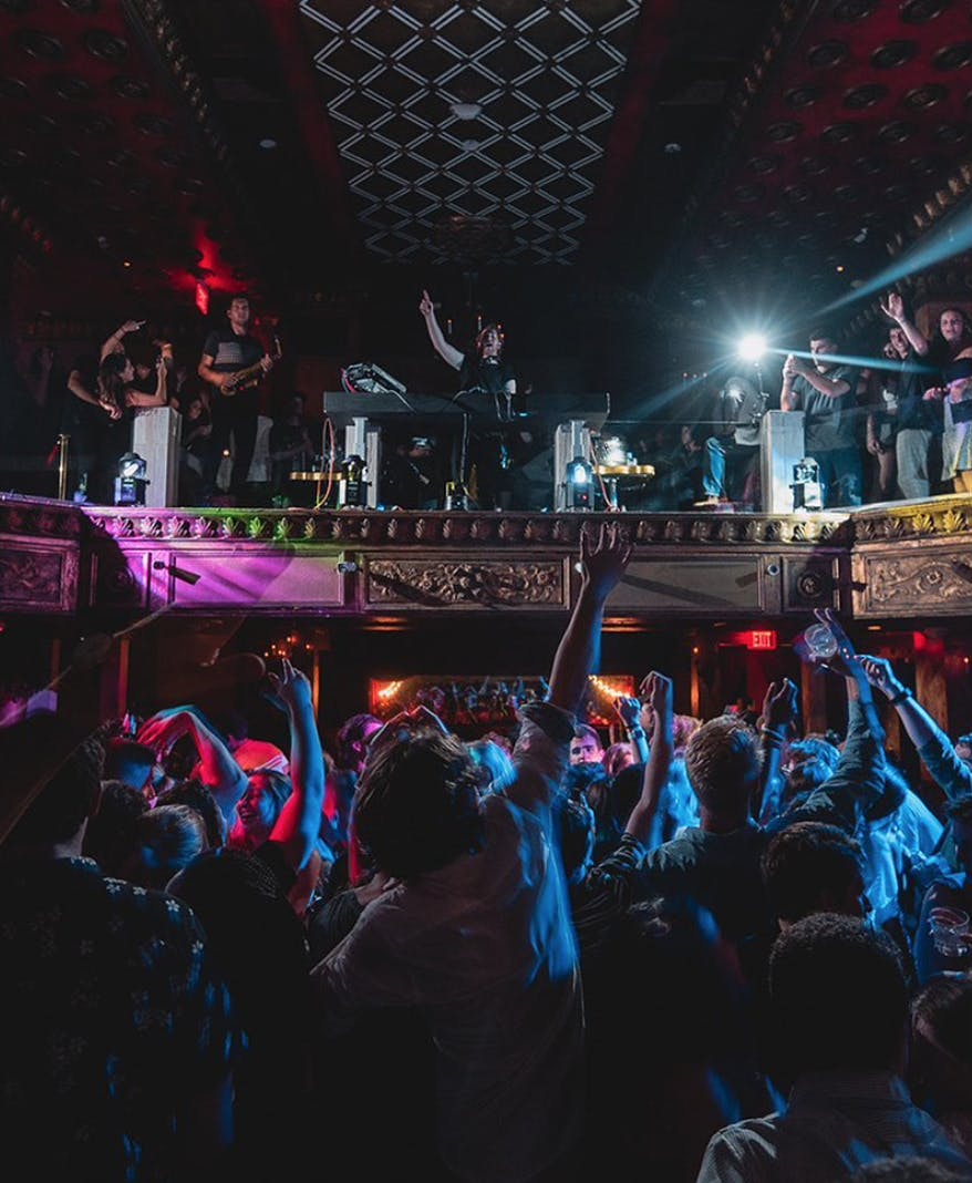 a group of people on a stage in front of a crowd