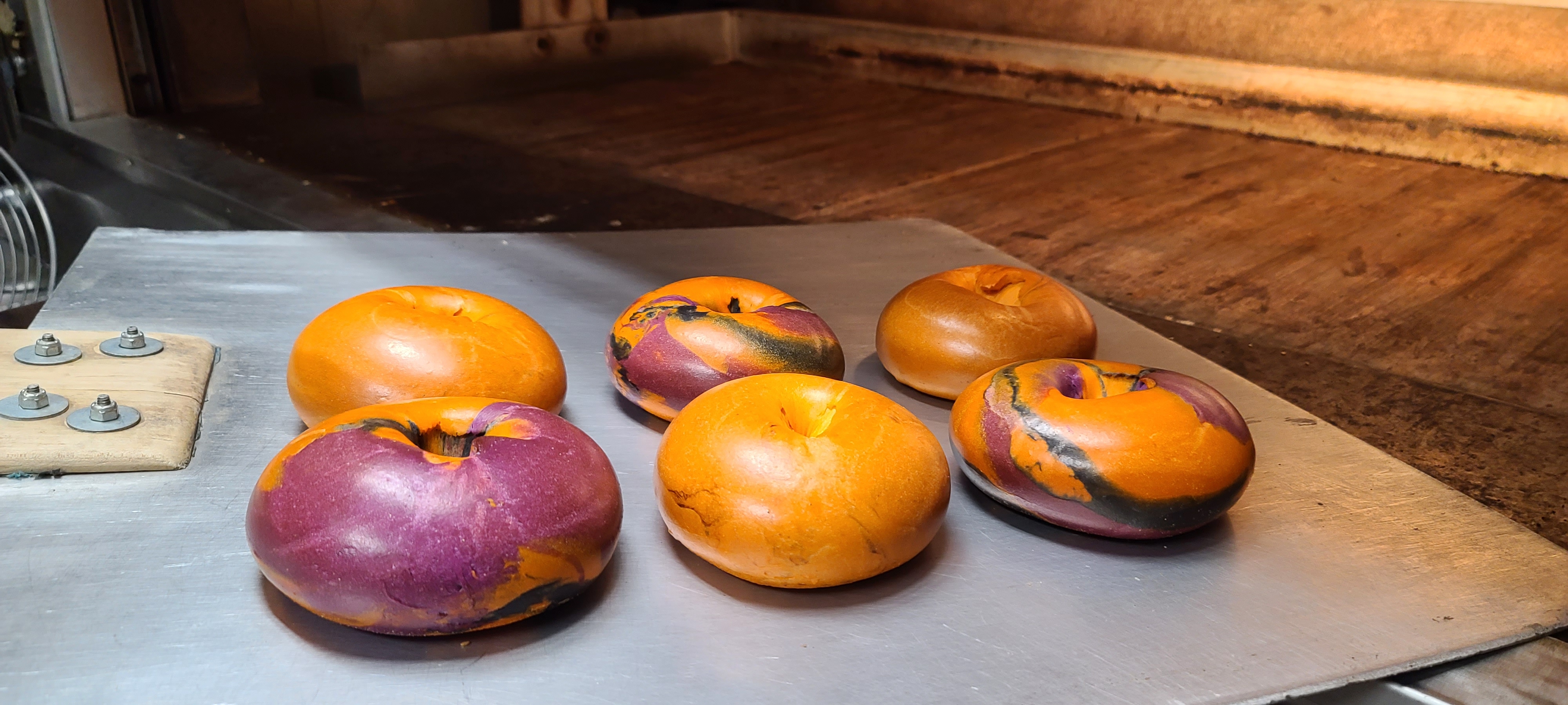 two oranges sitting on top of a wooden table