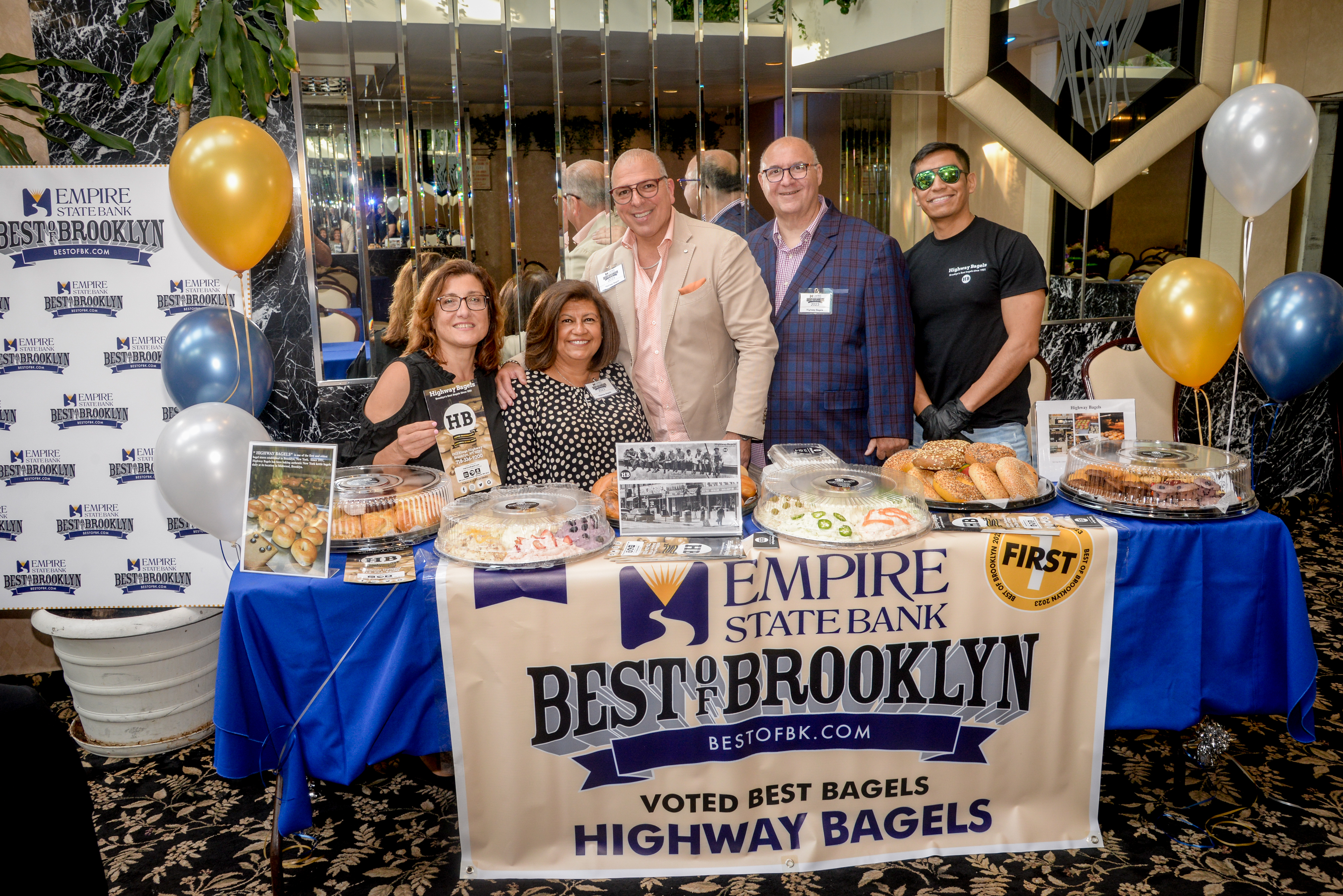 a group of people standing around a table