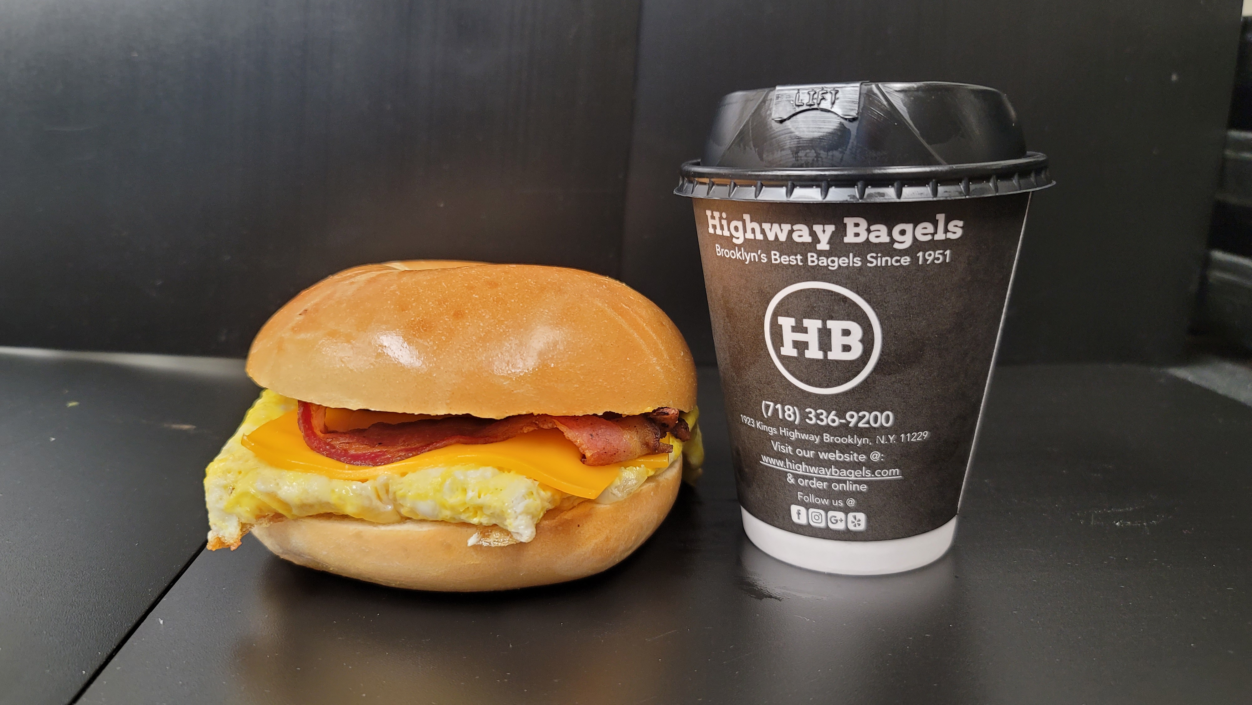 a close up of a sandwich and a cup of coffee