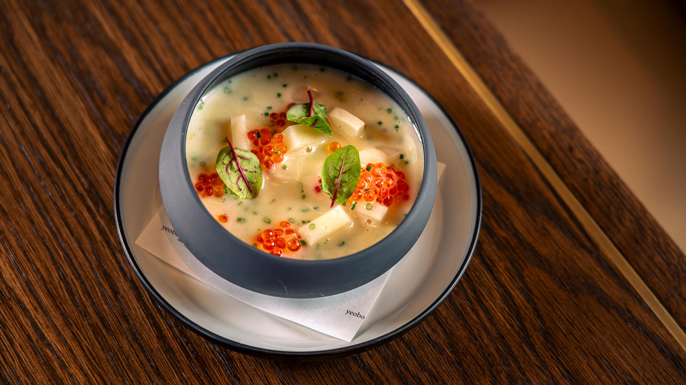 a bowl of soup with red and white caviar