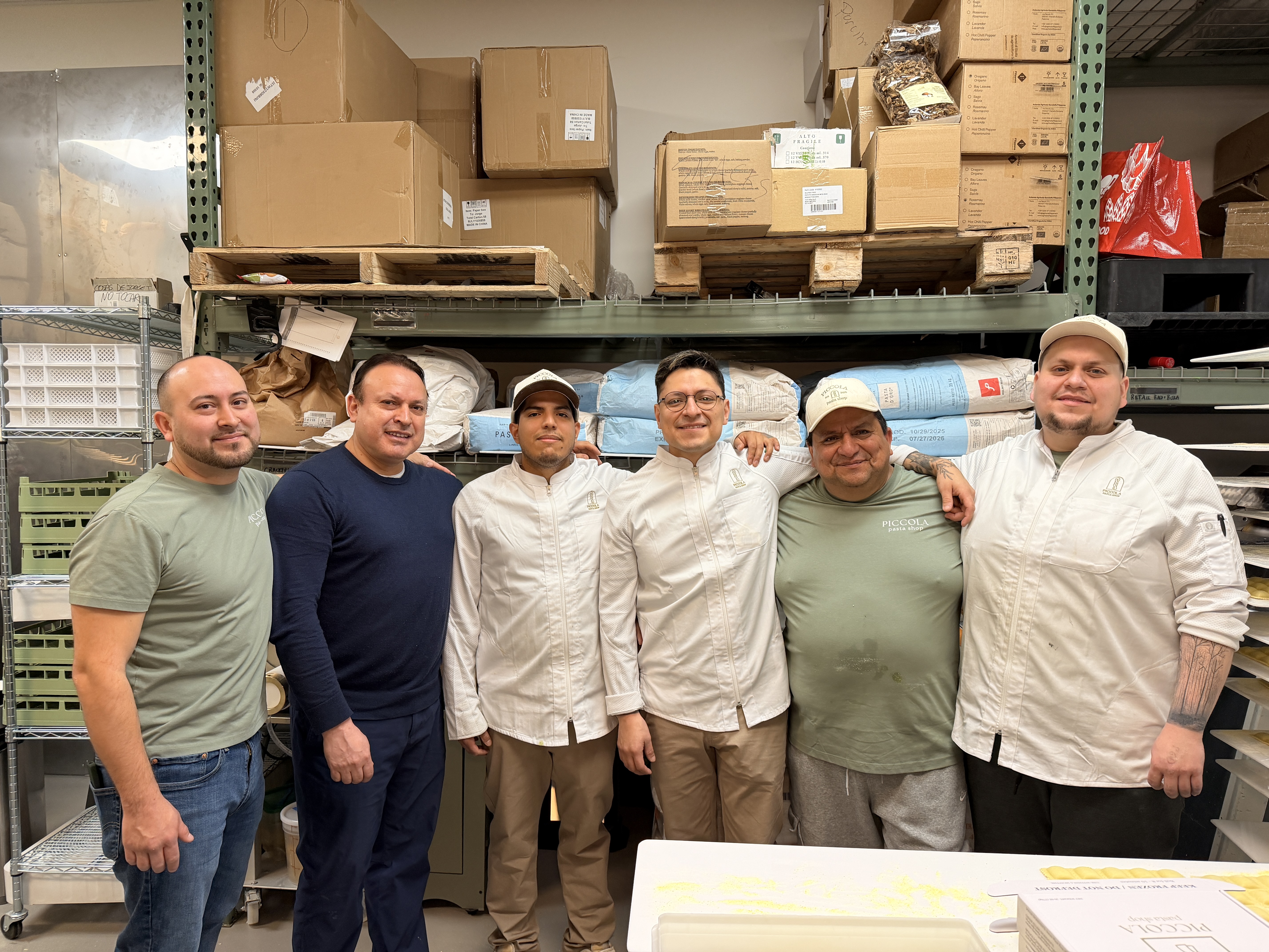 a group of men standing in a warehouse