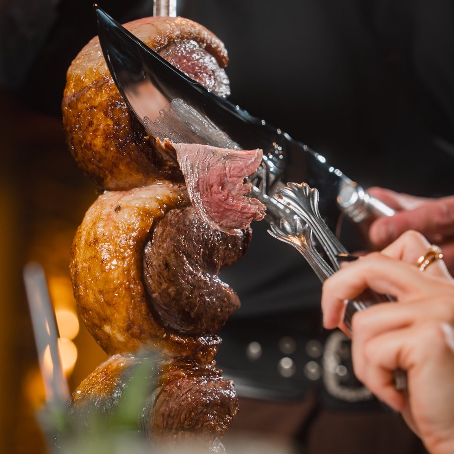 A gaucho carving meat tableside
