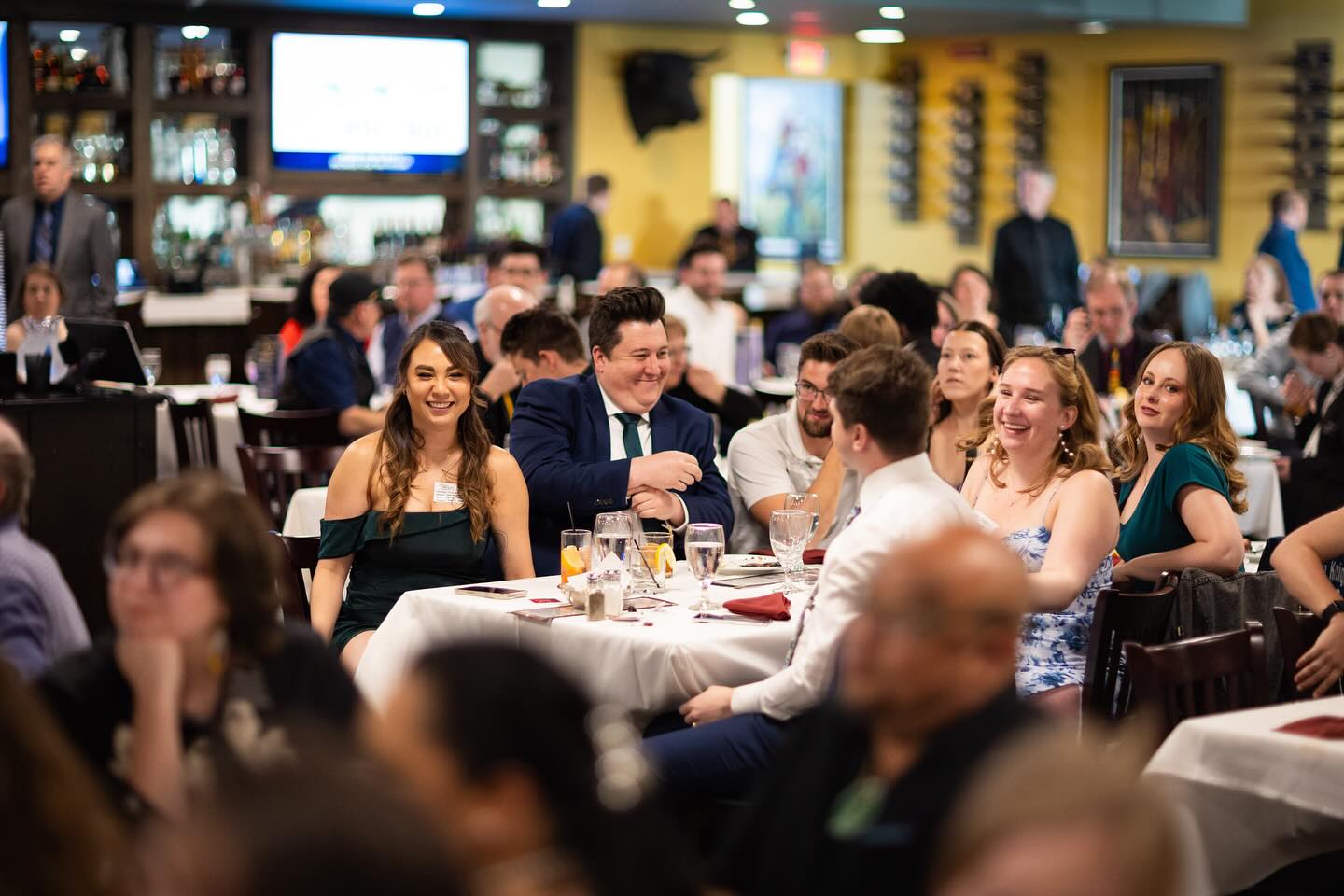 a group of people sitting at a table in front of a crowd