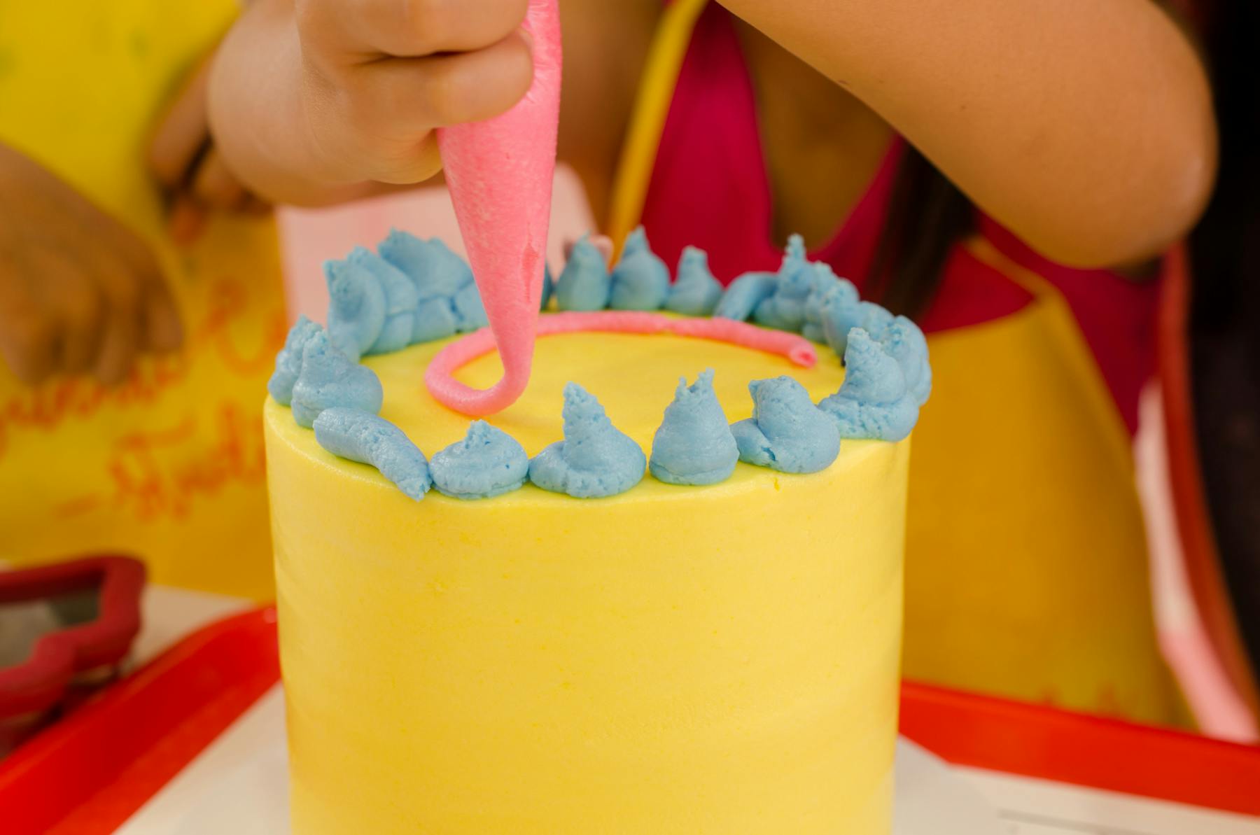 a close up of a person holding a birthday cake
