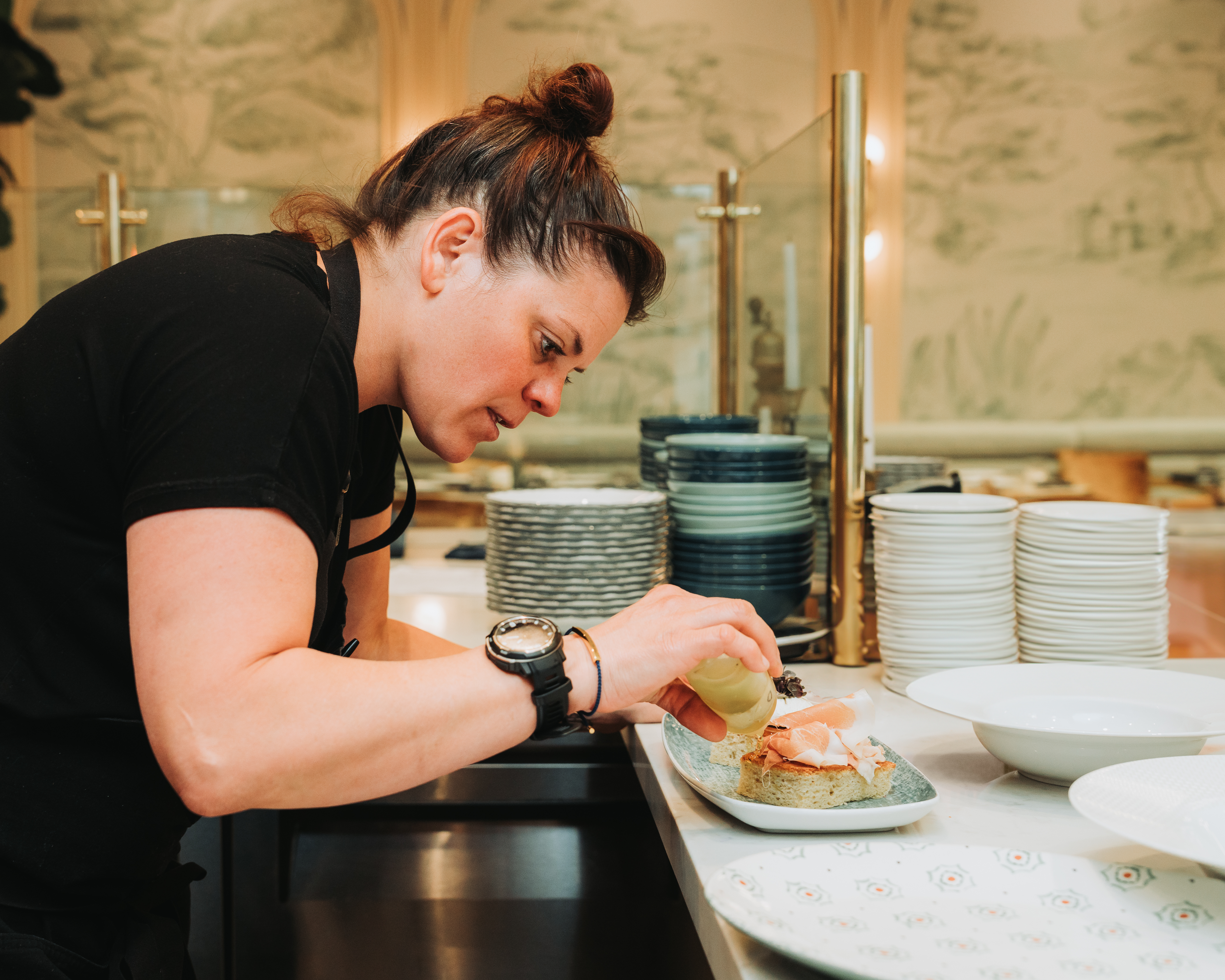 a woman preparing food in a kitchen