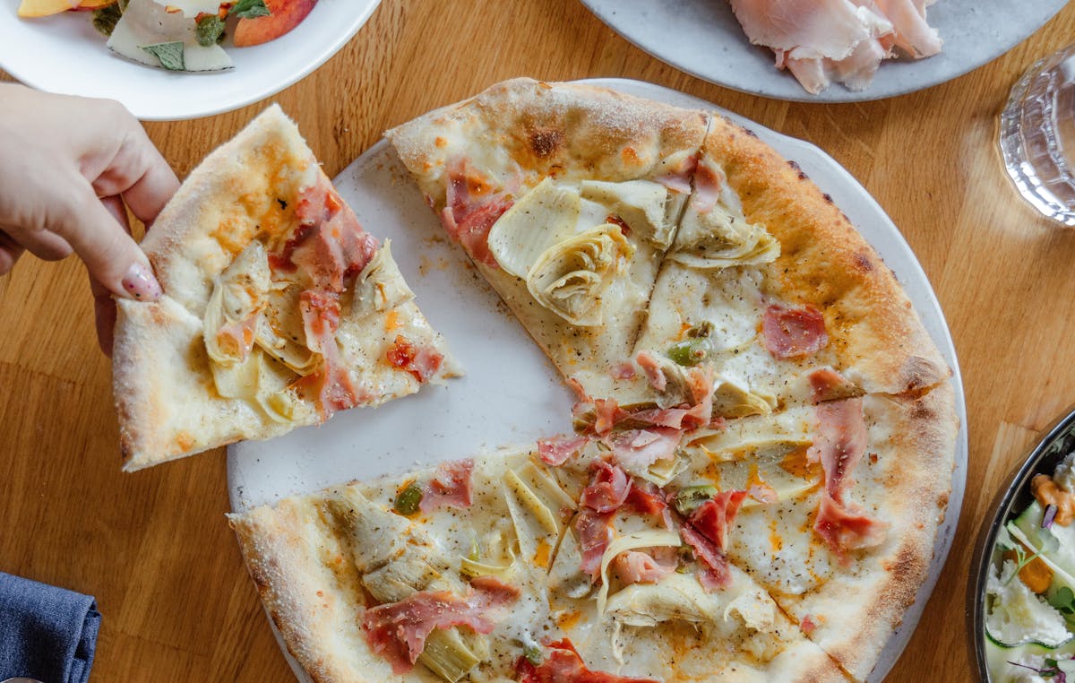 a plate of food with a slice of pizza