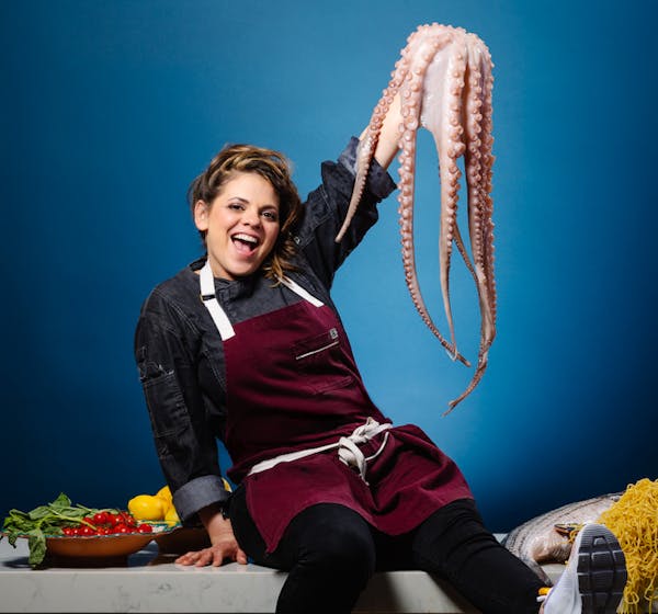 a woman holding seafood