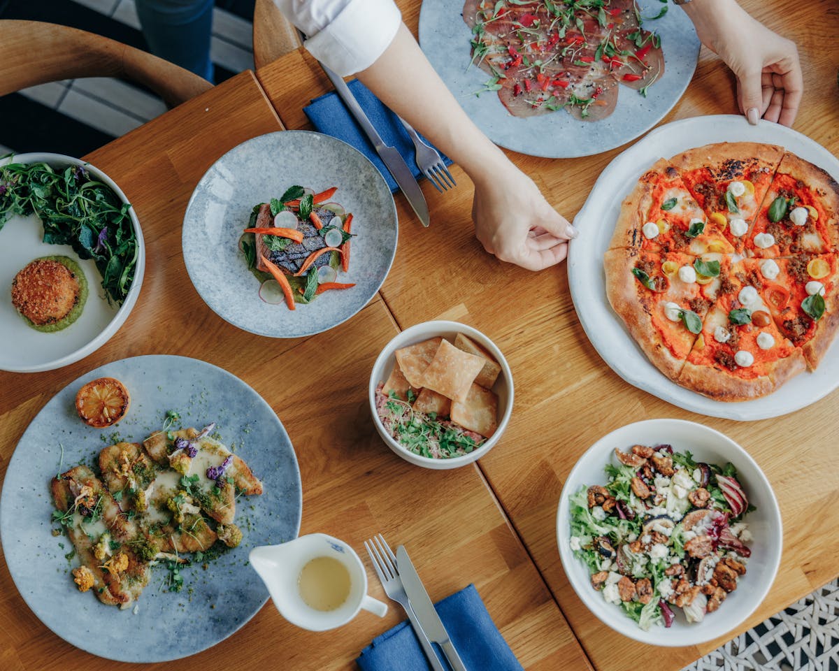 a group of people sitting at a table with a plate of food