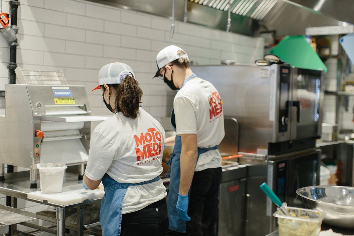 a man standing in a kitchen preparing food
