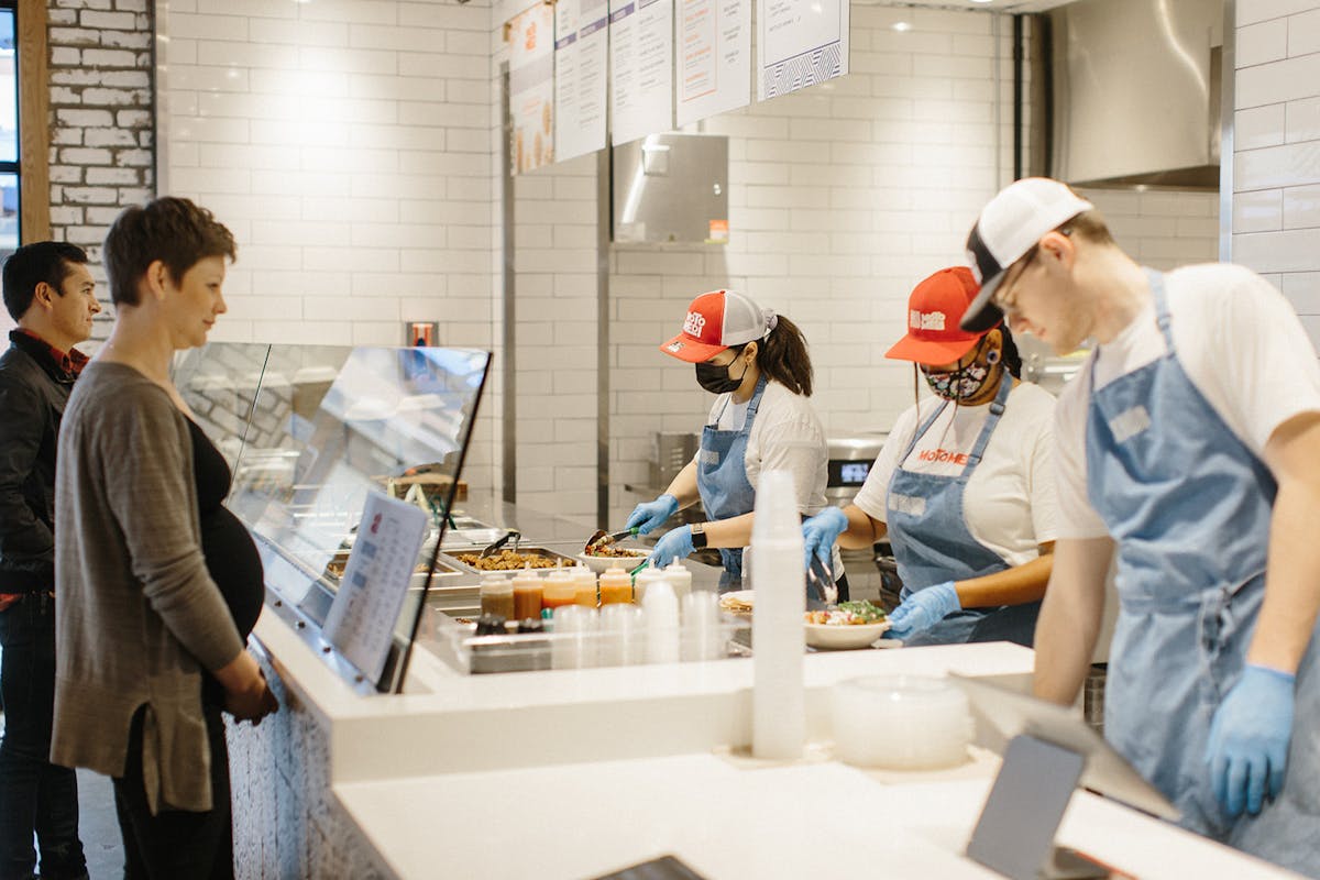 a group of people preparing food in a kitchen