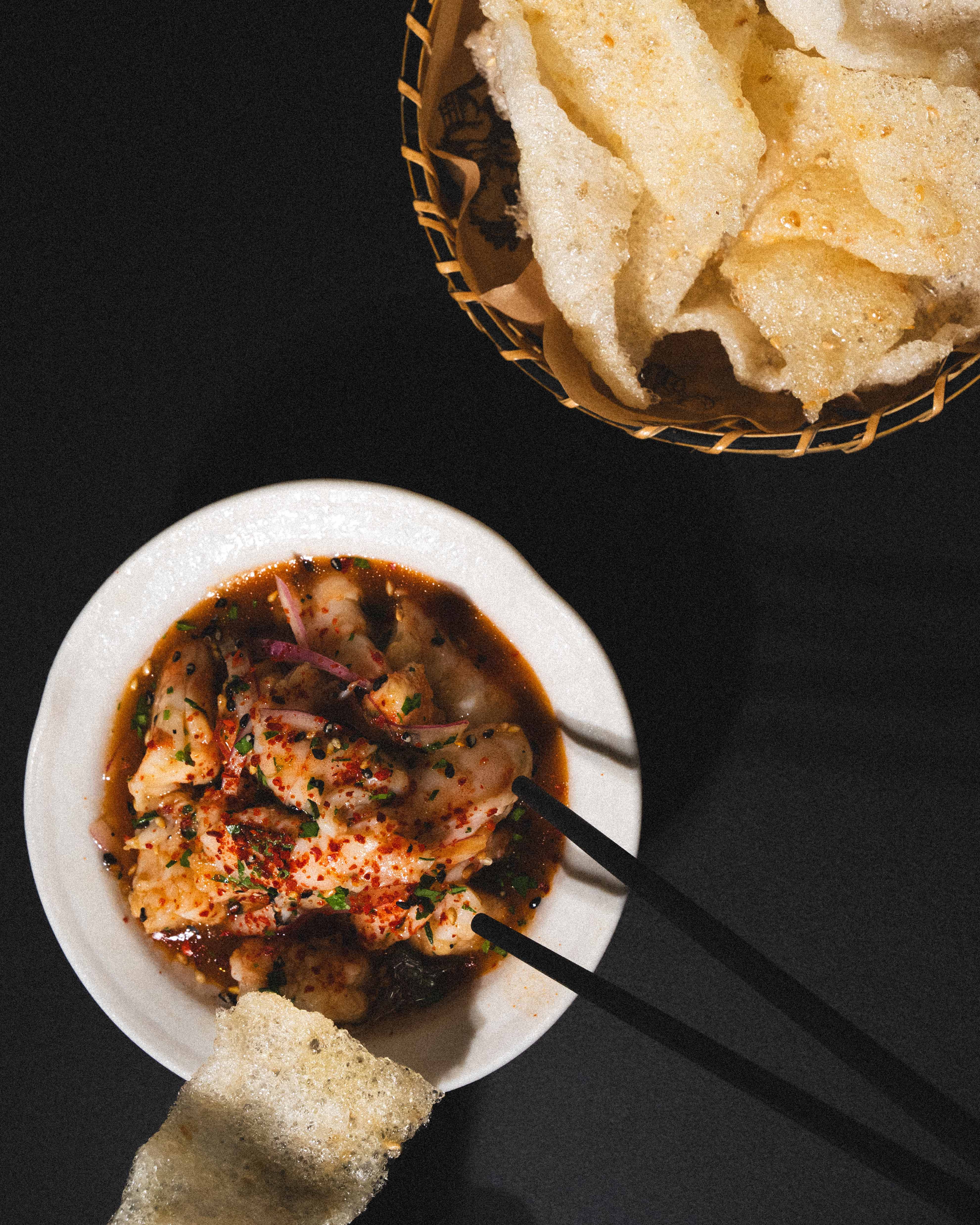 a bowl of food with chopsticks