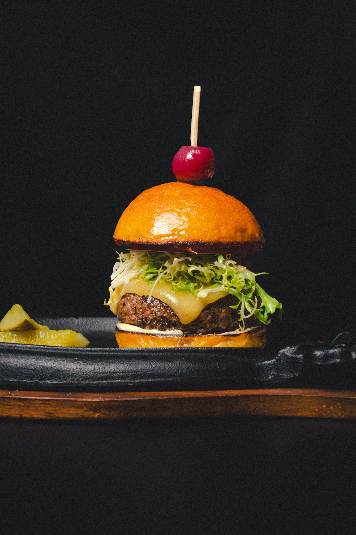 a burger with a cherry on top