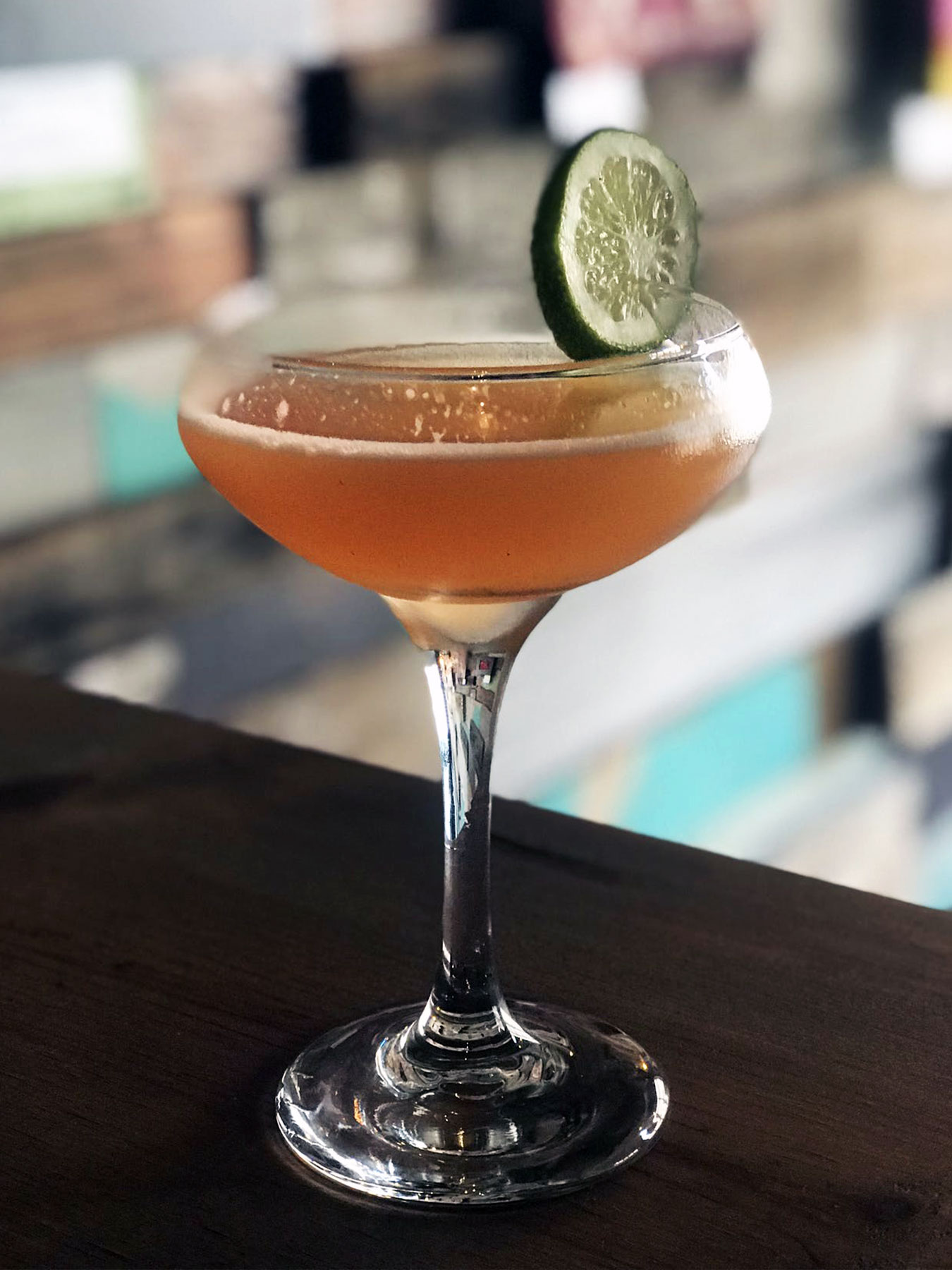 a close up of a wine glass sitting on a table