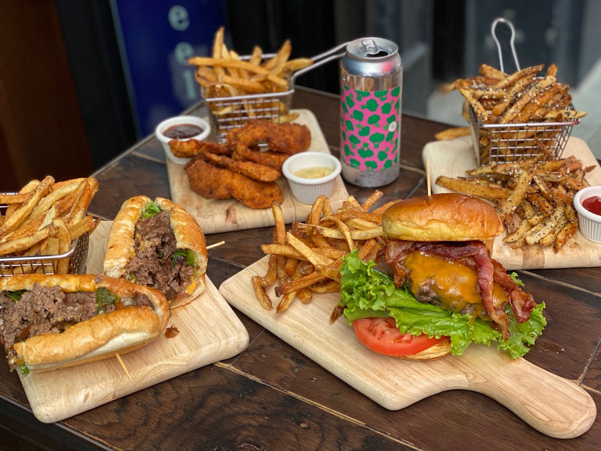 a cut in half sandwich sitting on top of a wooden cutting board