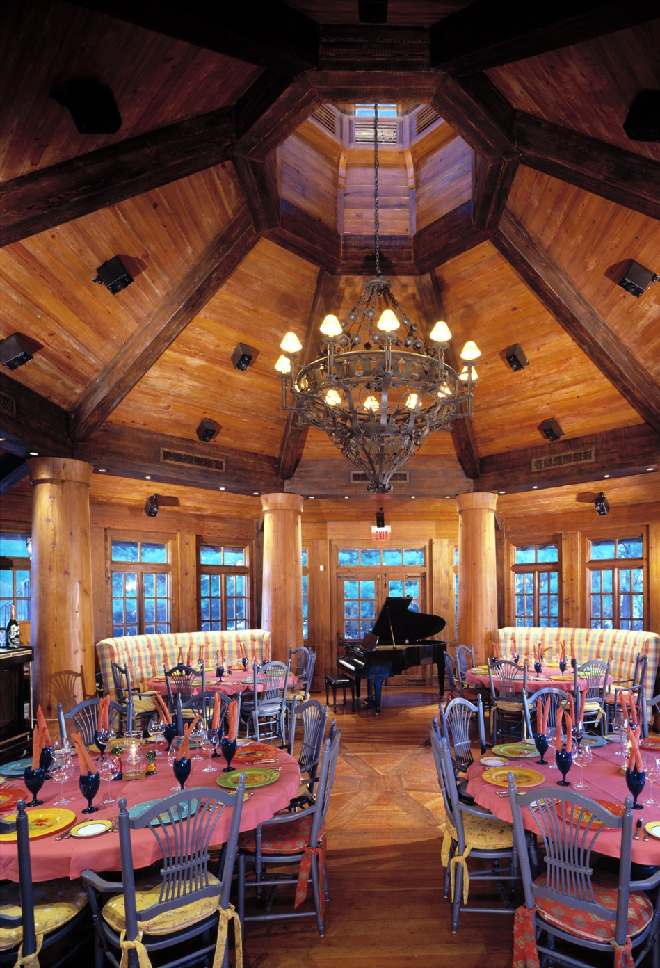 a room with a piano and tables