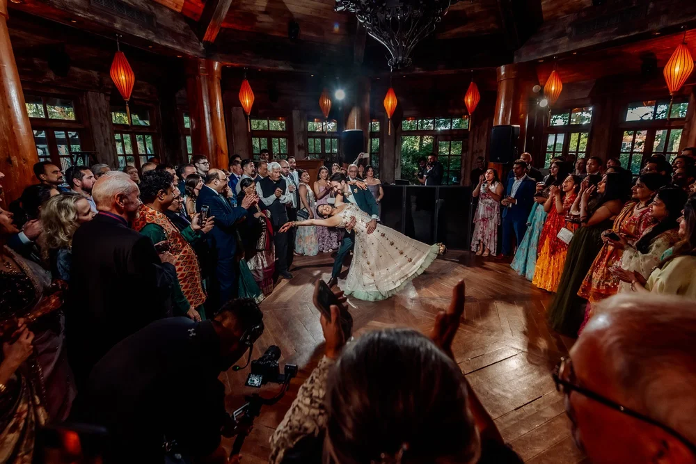 a woman dancing in a room with a crowd of people