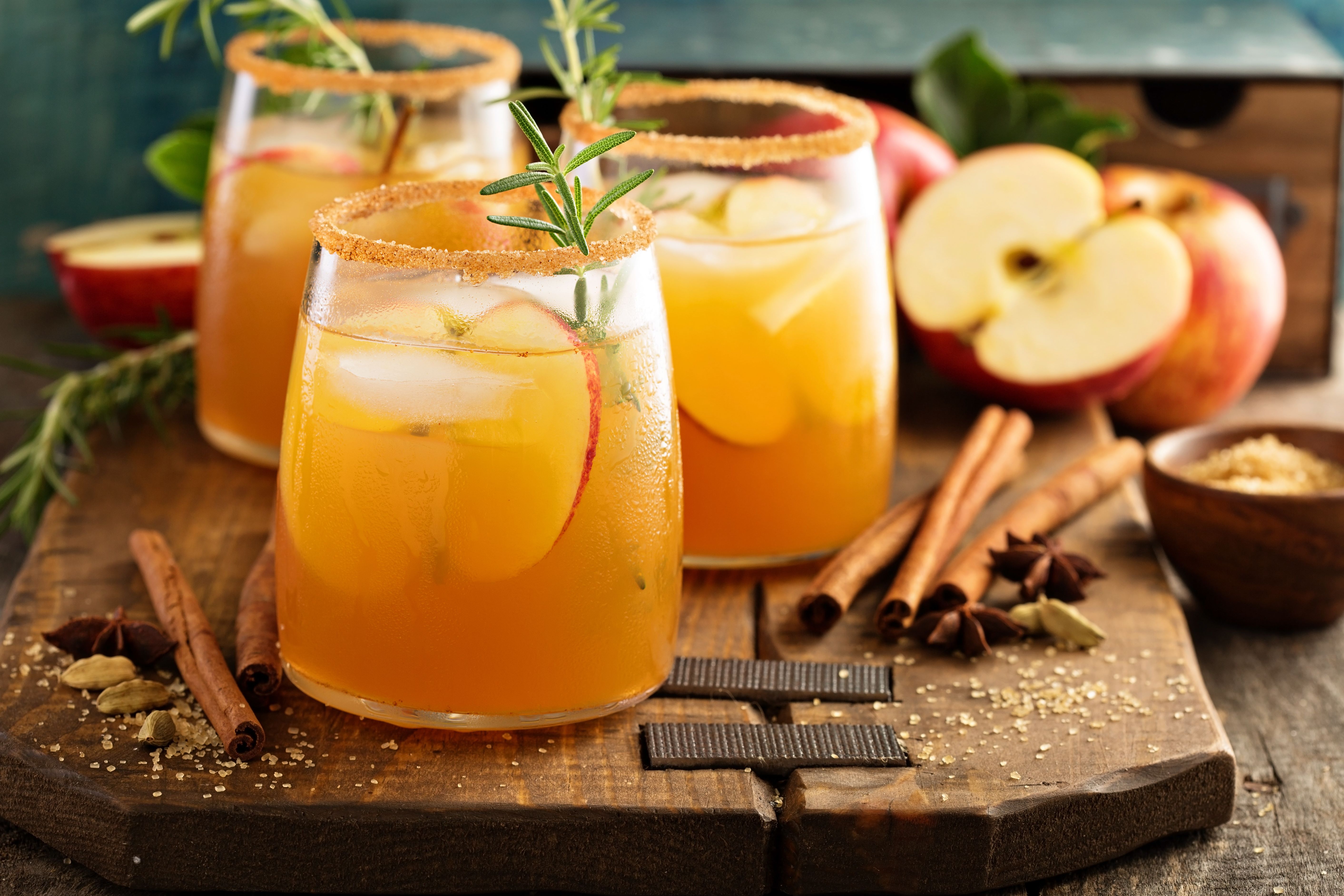 a group of glasses with liquid and cinnamon sticks