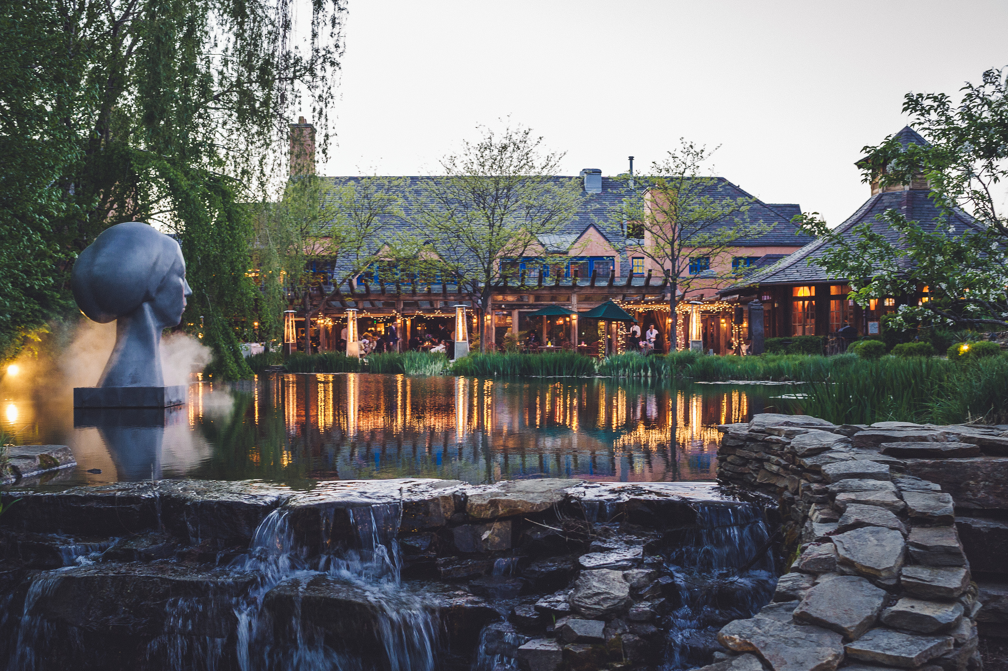 a fountain with a body of water in front of a building