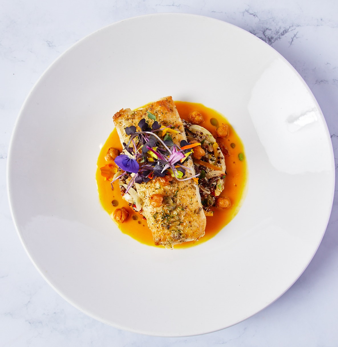a plate of food on a marble surface