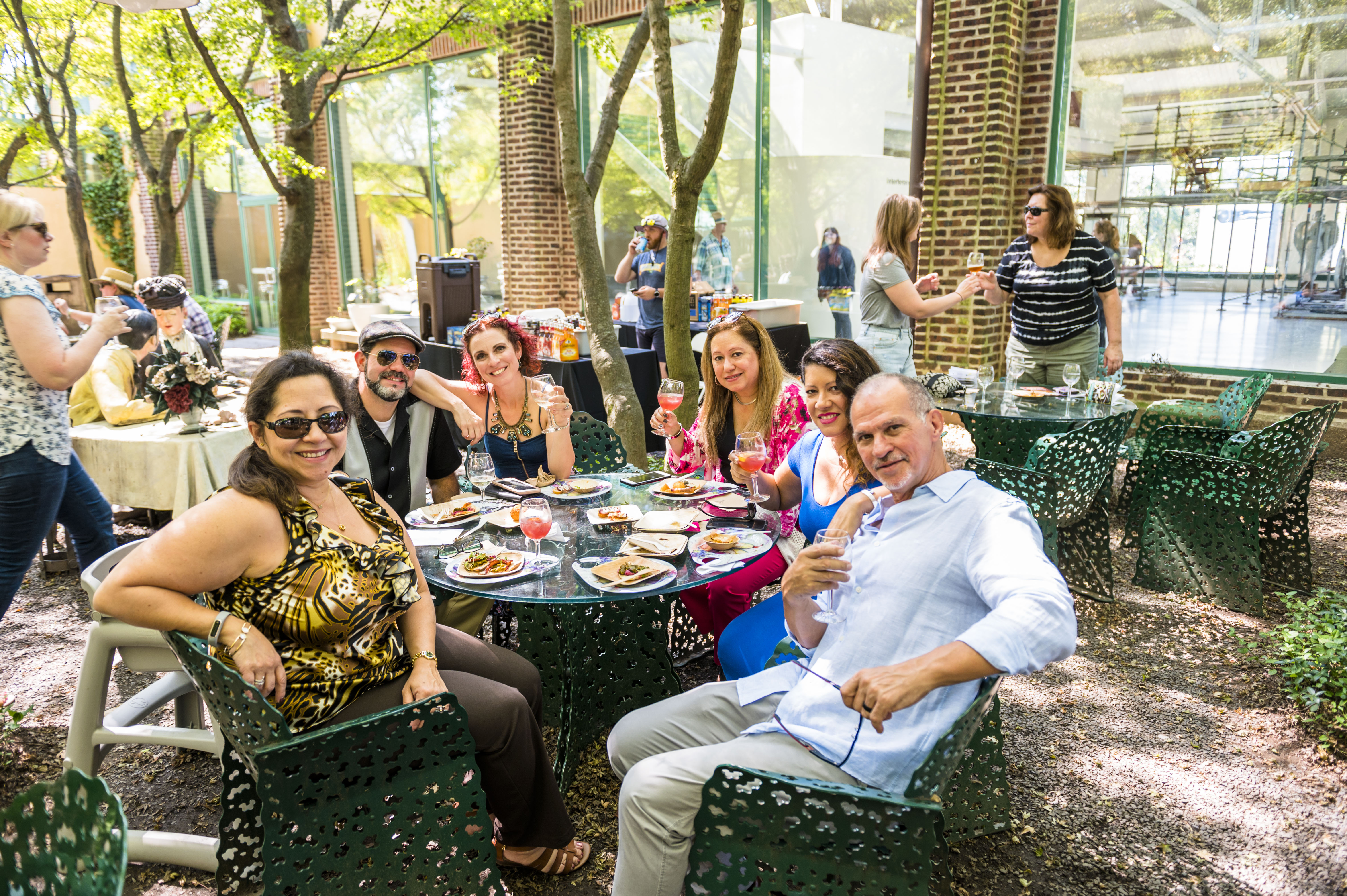 a group of people sitting at a table outside