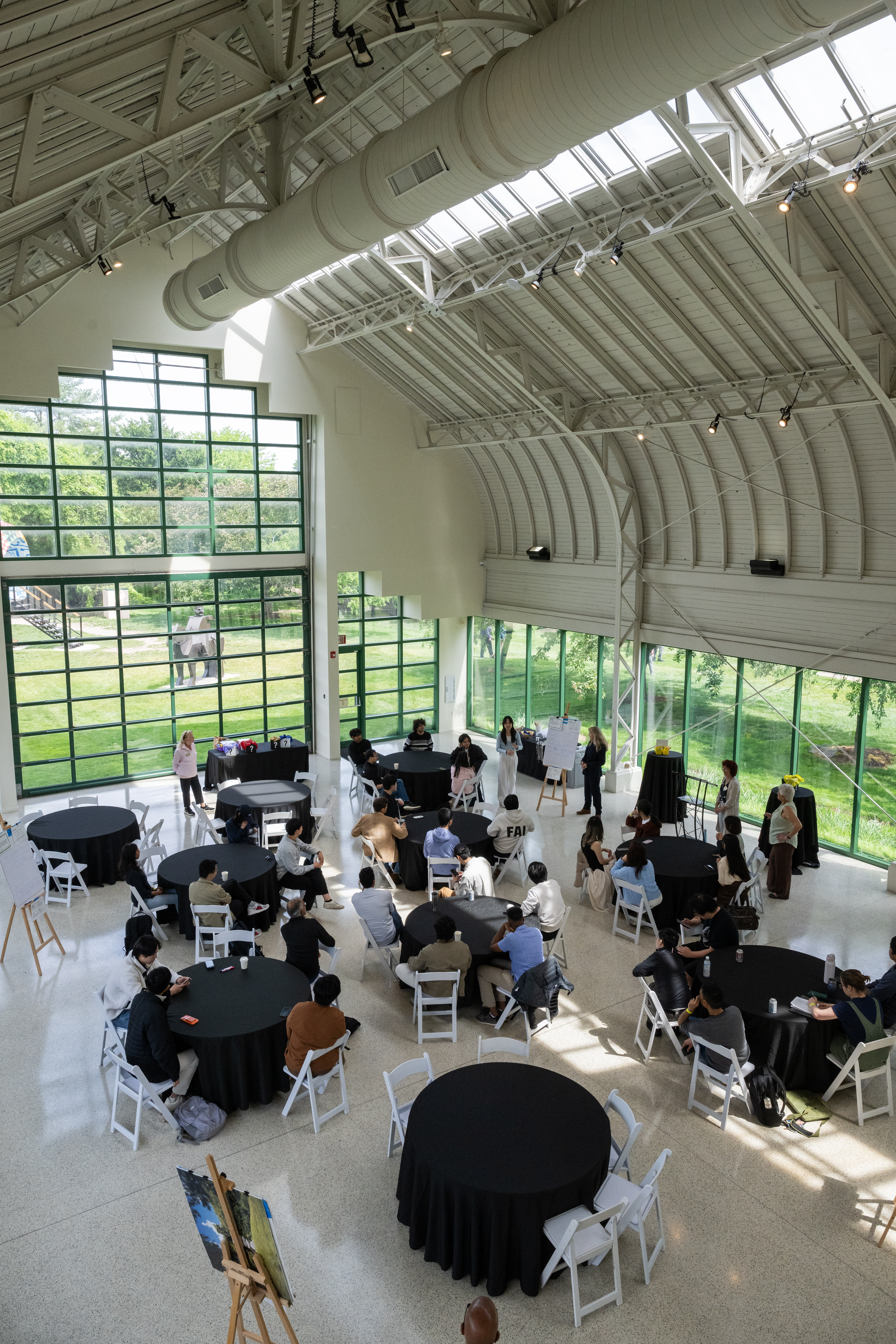 a group of people sitting at tables in a large room