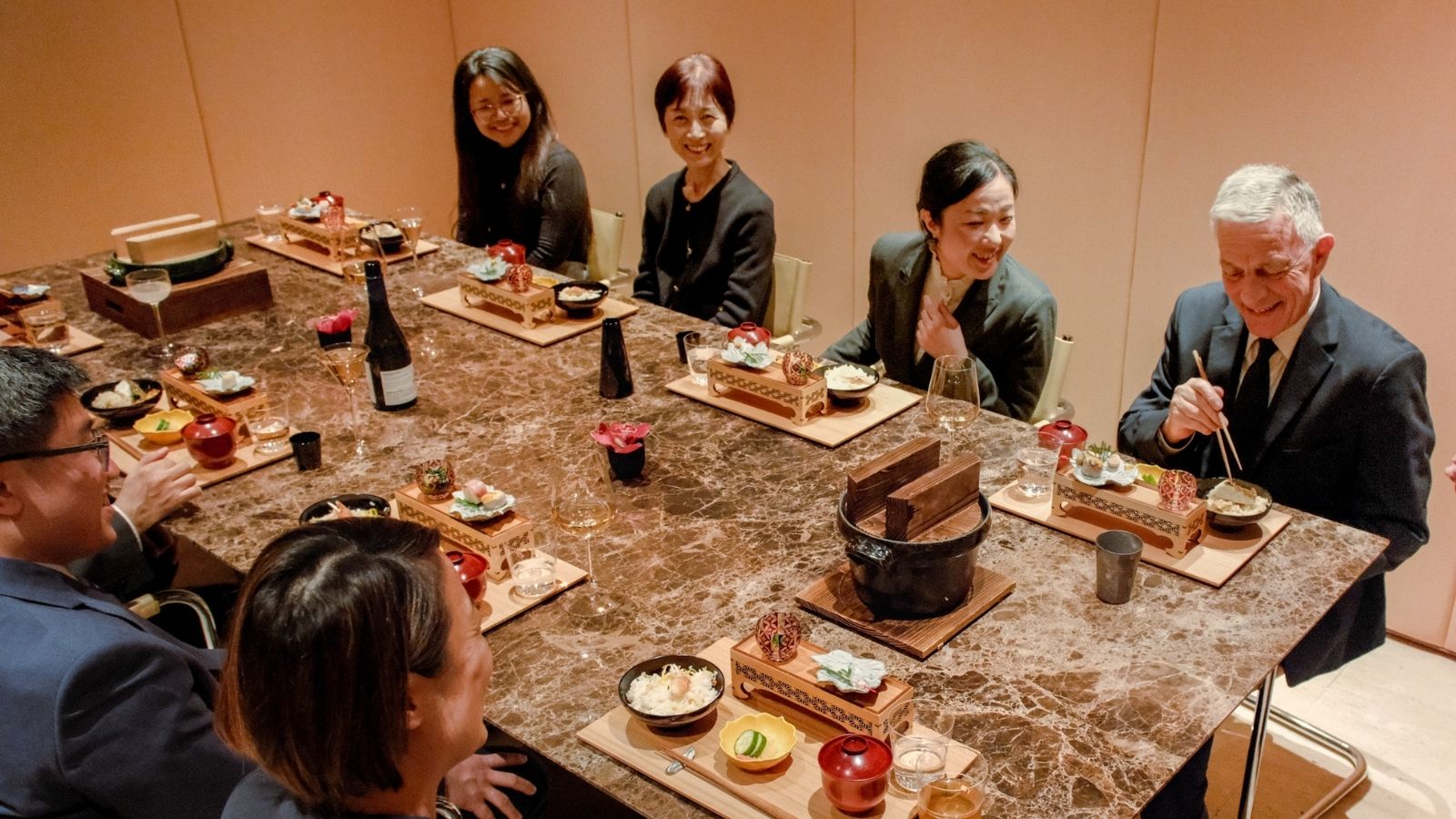 a group of people sitting at a table eating food