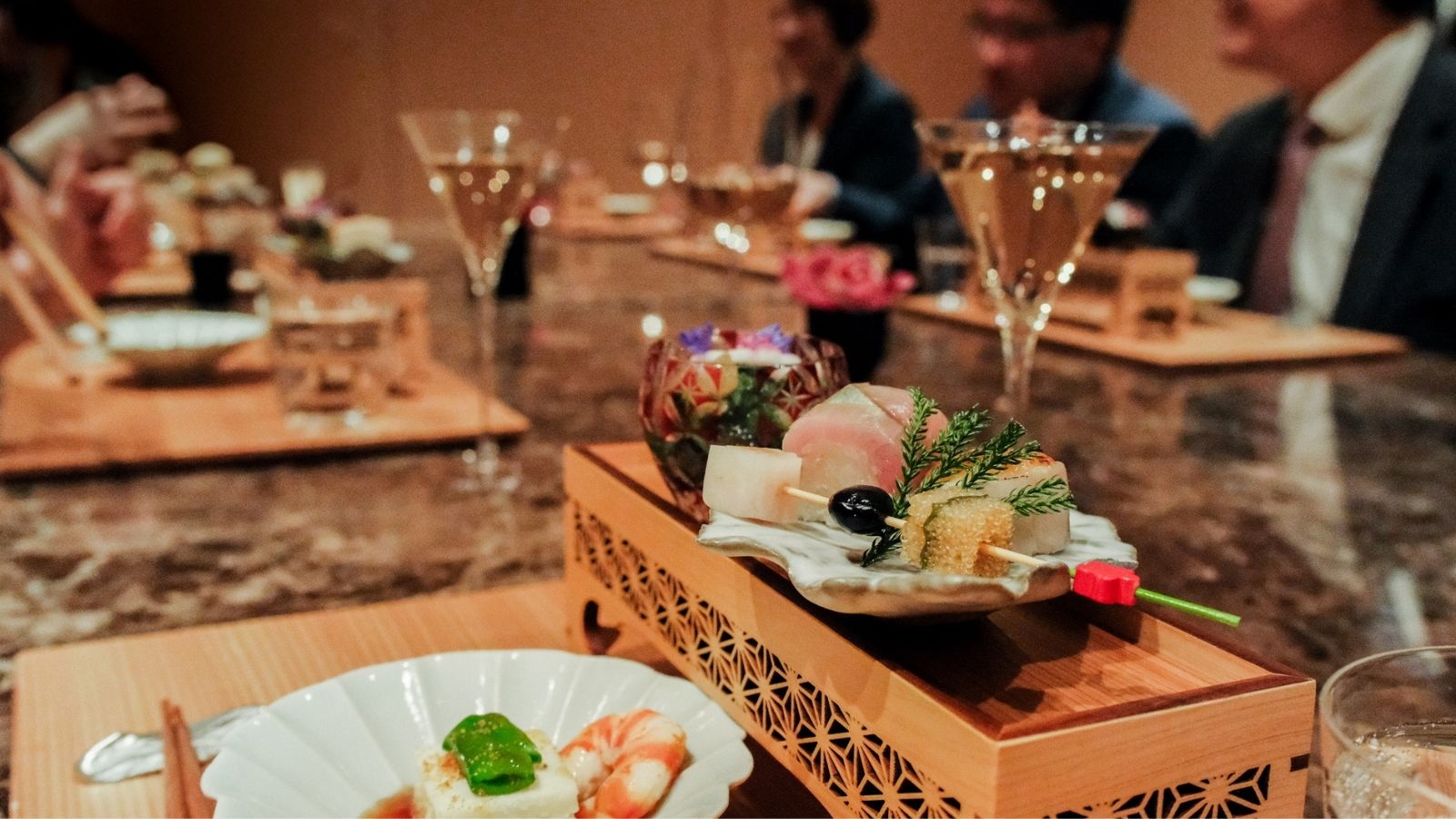 a plate of food and glasses of wine