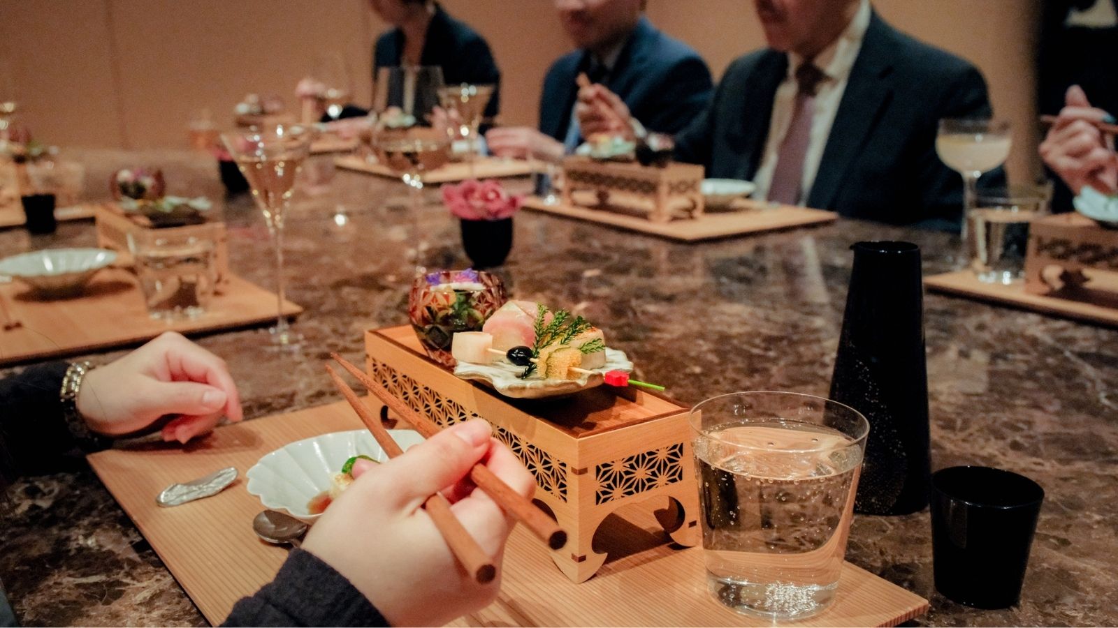 a person sitting at a table with a cup of coffee