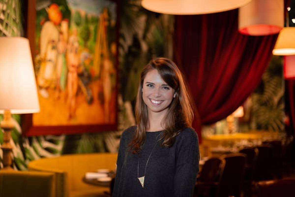 a woman standing in front of a table