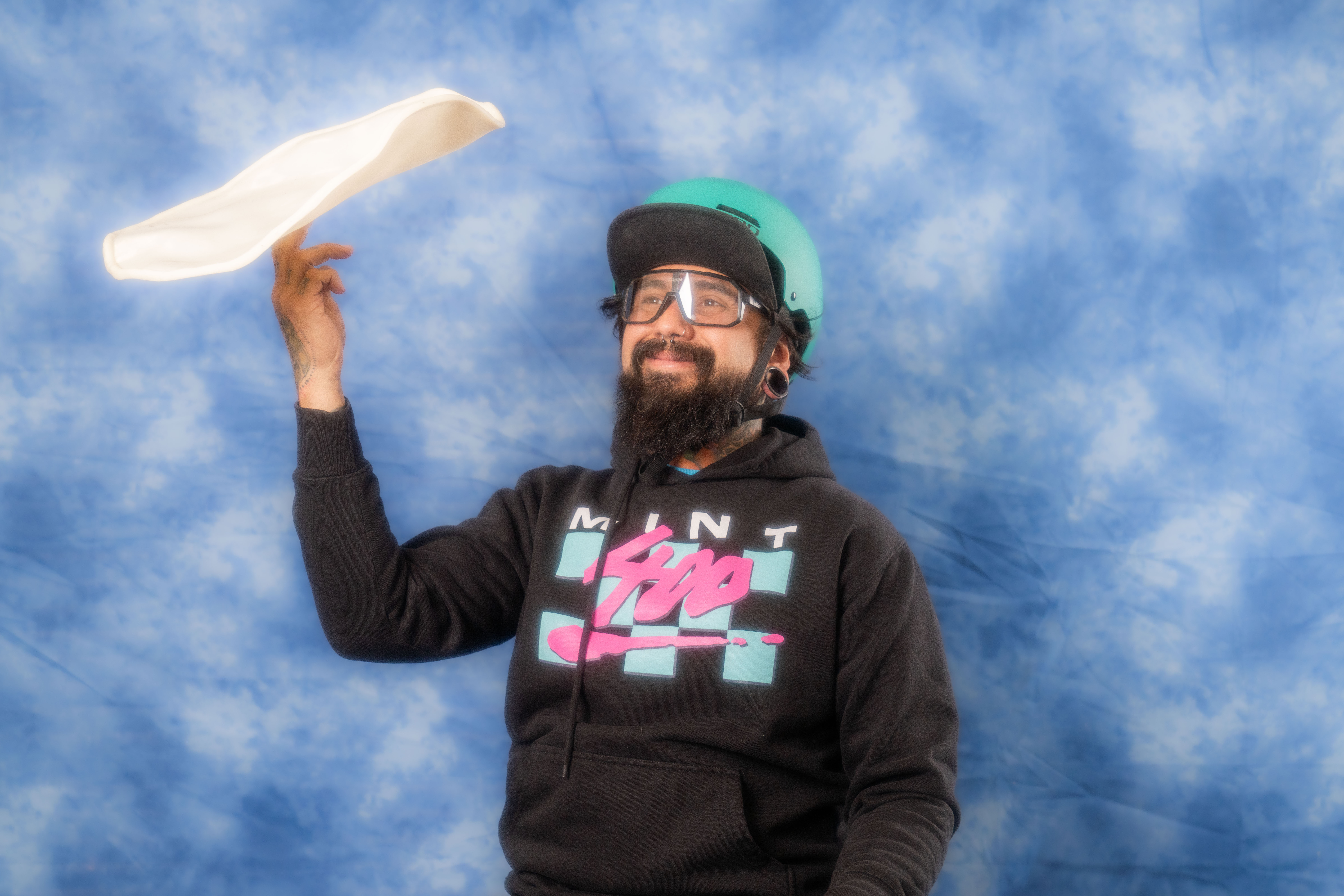 a man wearing a hat and sunglasses posing for the camera