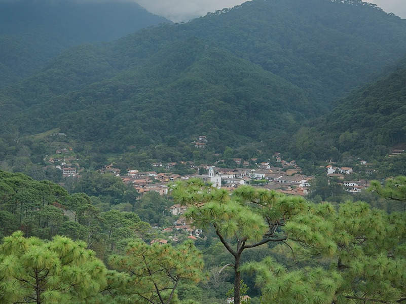 a large body of water with a mountain in the background