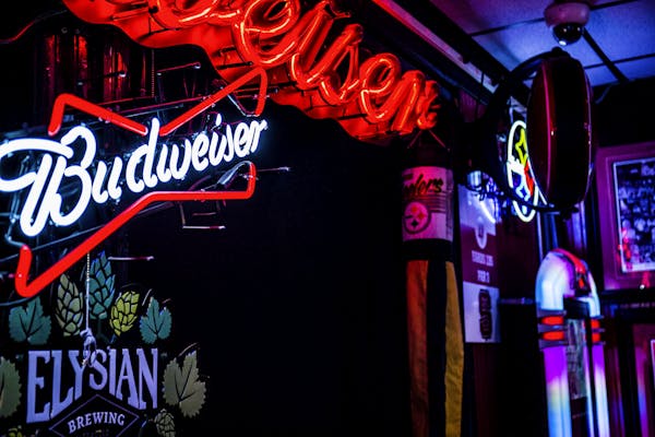 a red sign above the entrance of a bar and restaurant