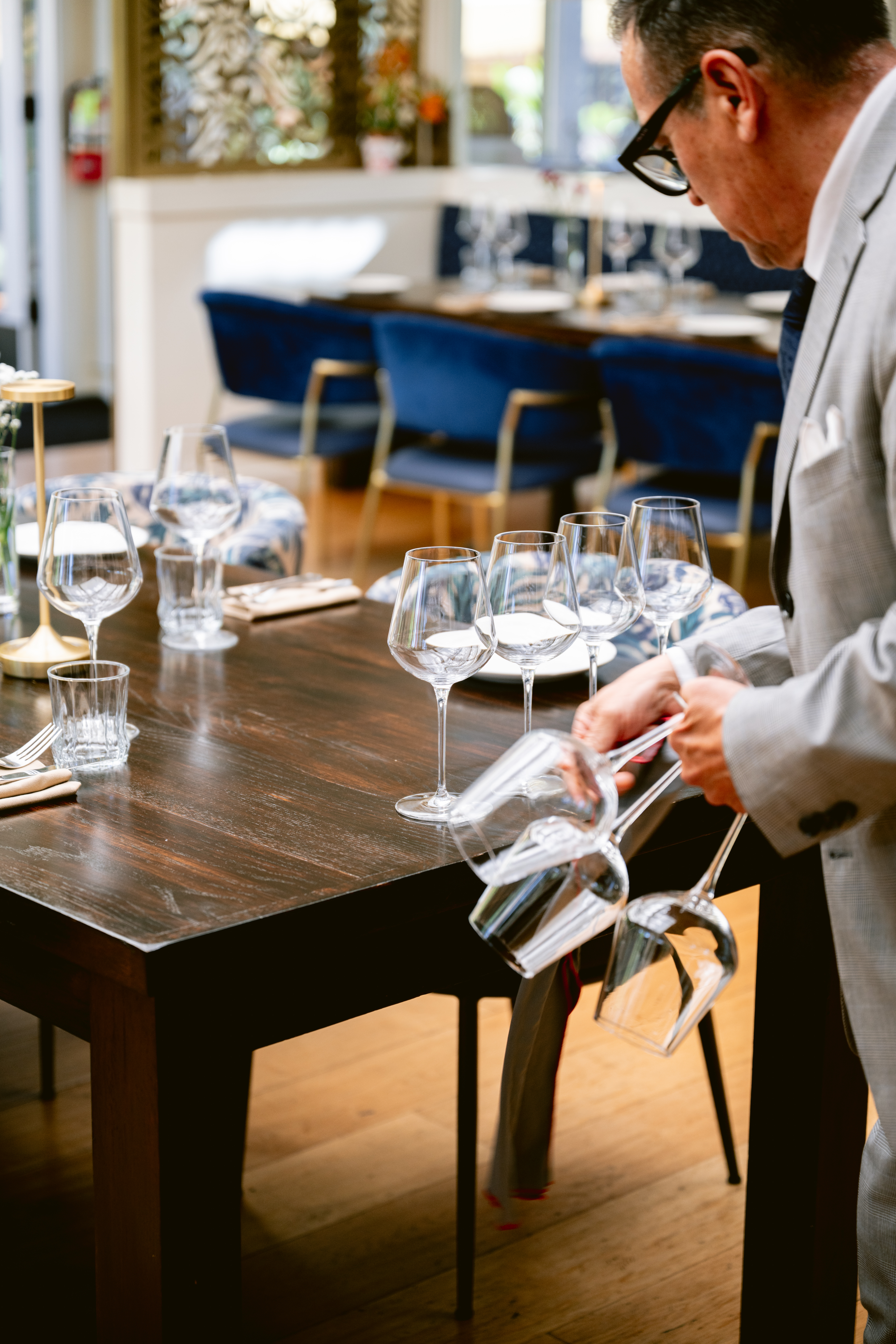 a man holding wine glasses