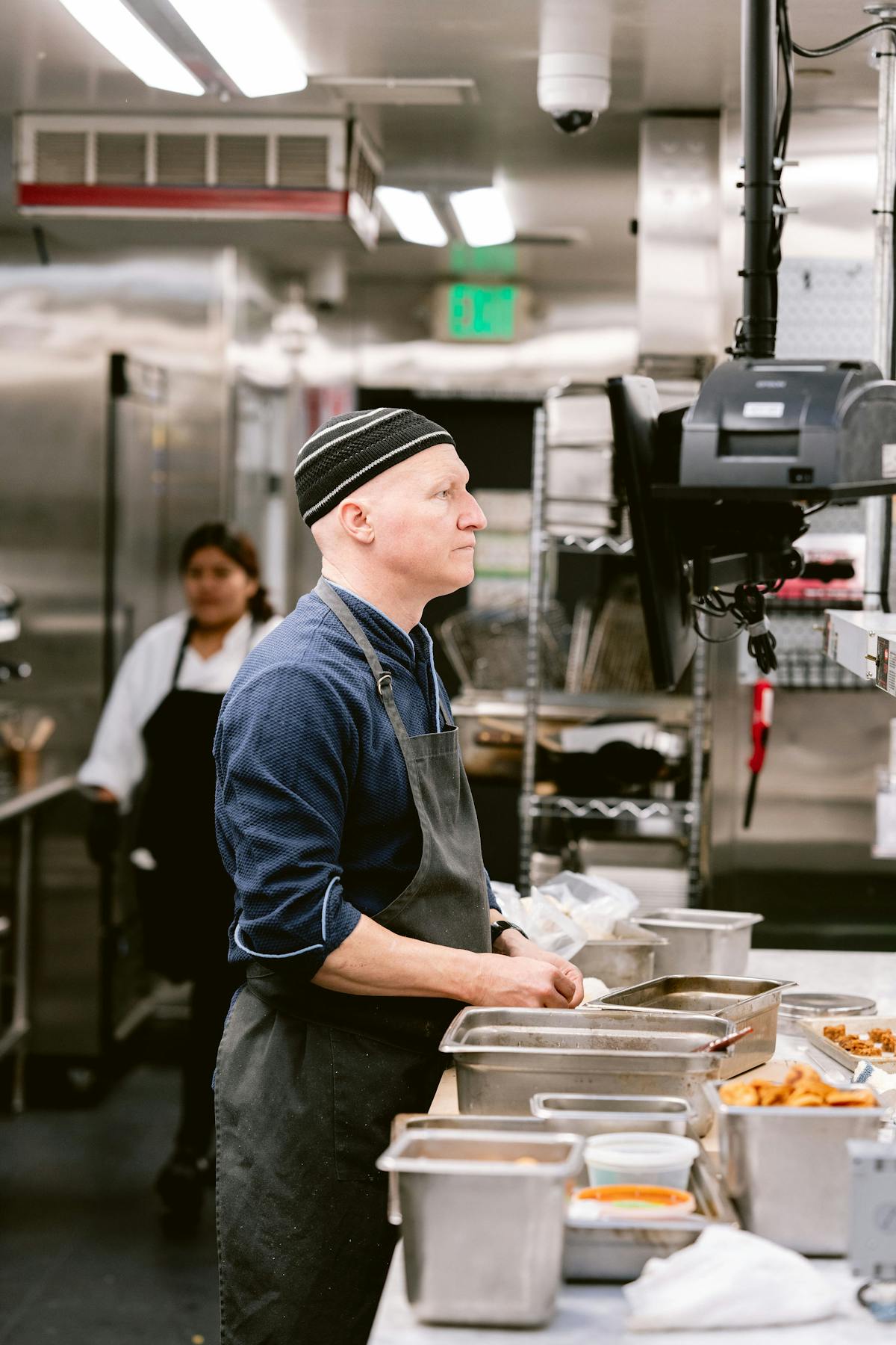 a man standing in a kitchen preparing food