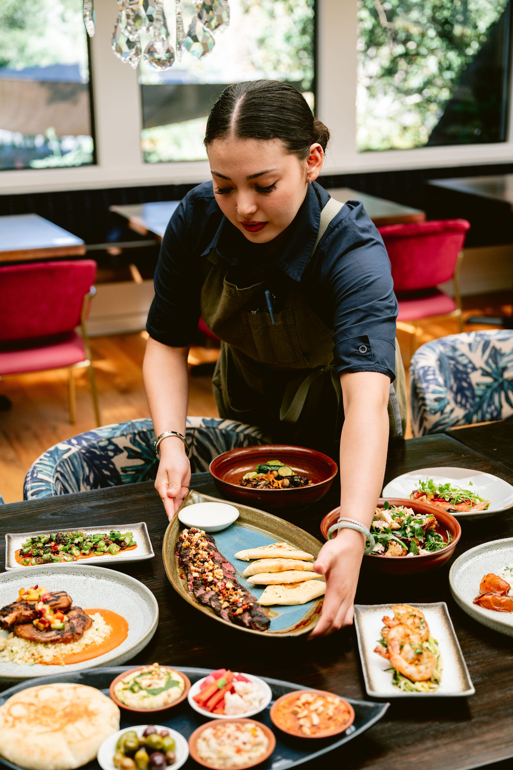a person sitting at a table with a plate of food