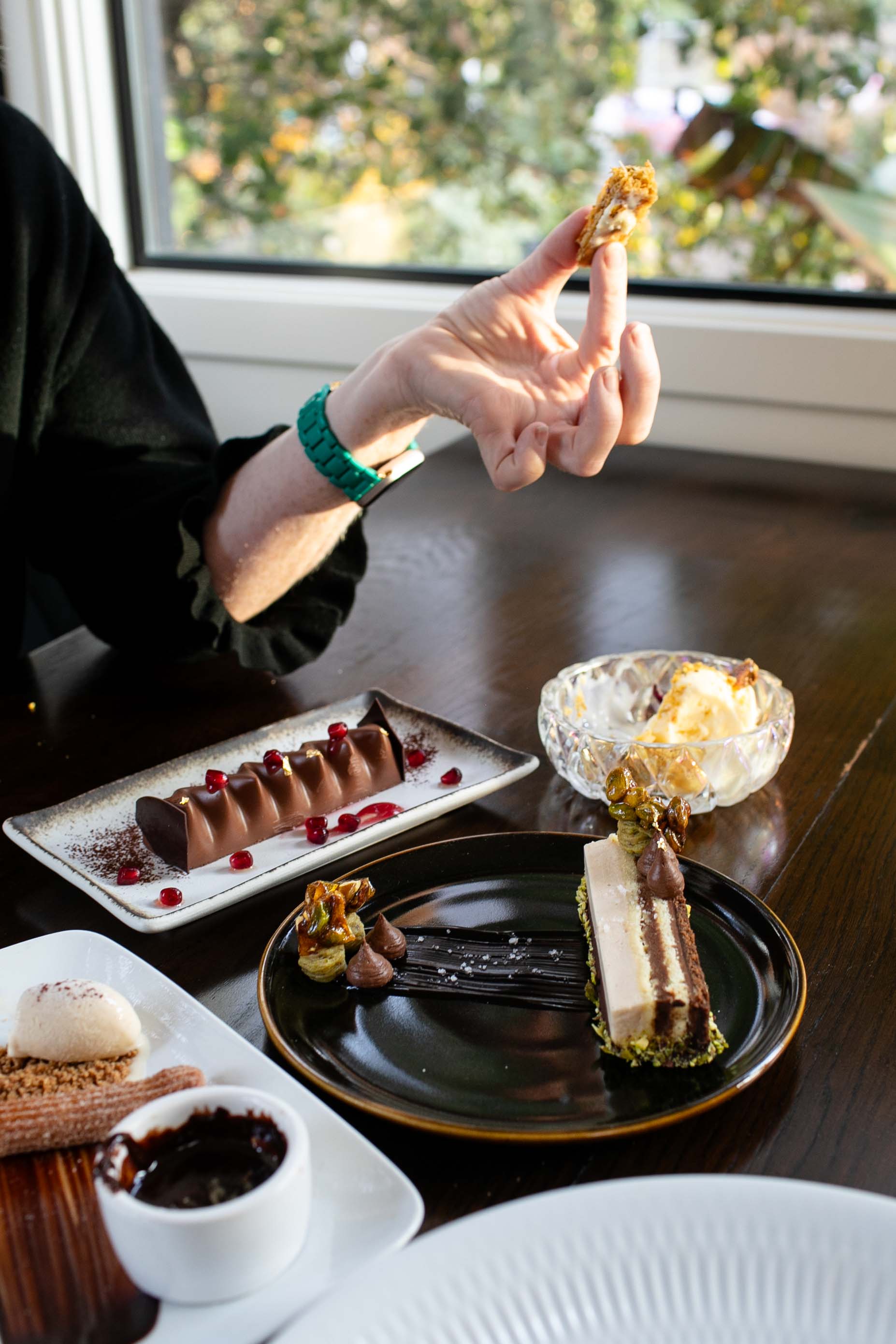 a person sitting at a table with a plate of food