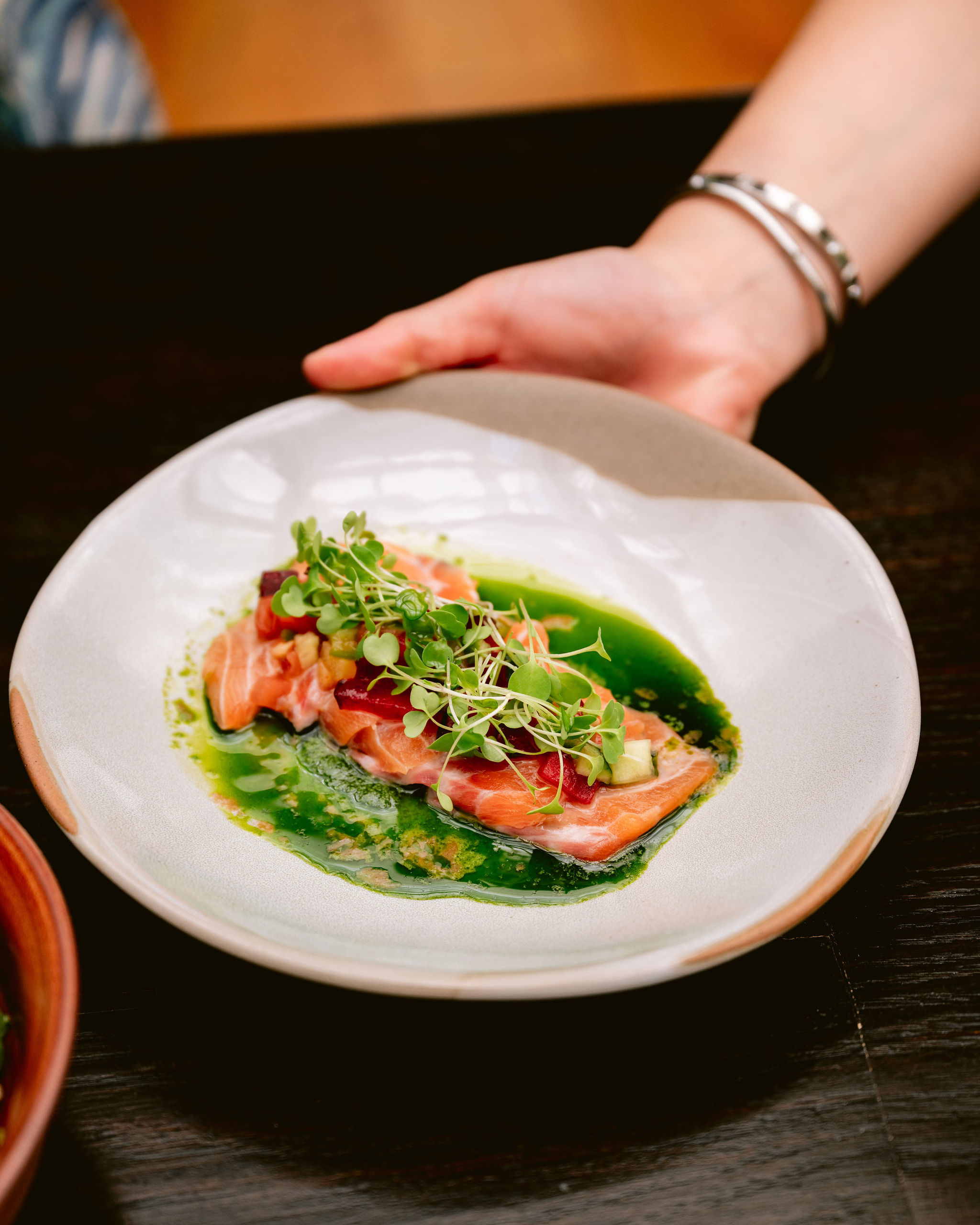 a person sitting at a table with a plate of food